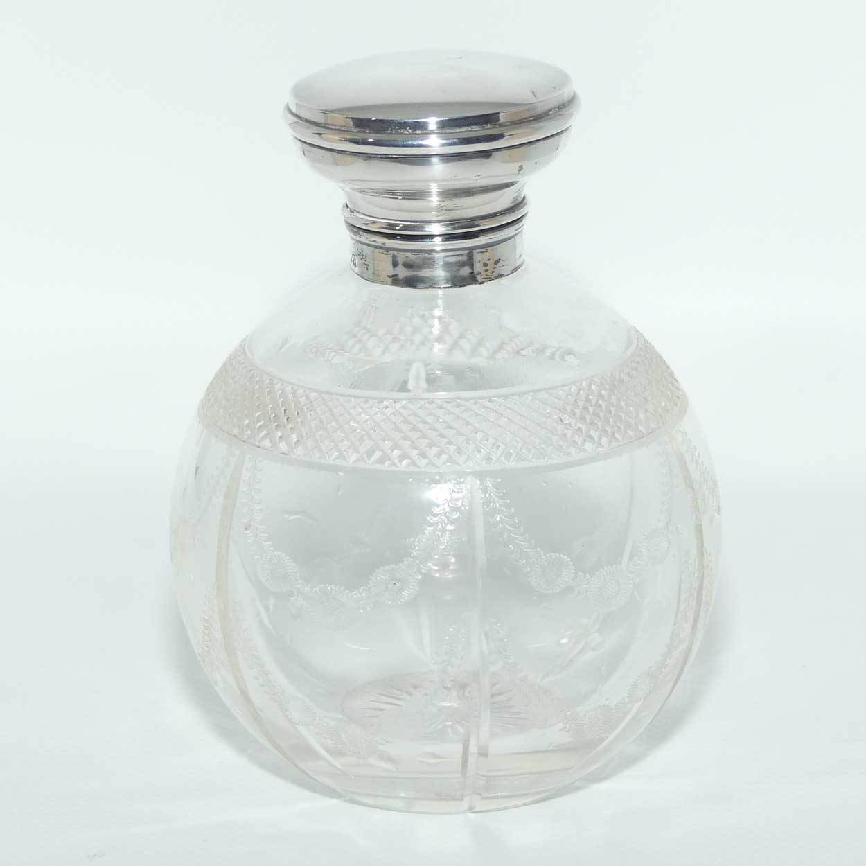 Edwardian era Sterling Silver and cut crystal perfume bottle with fine garlands of flowers decoration