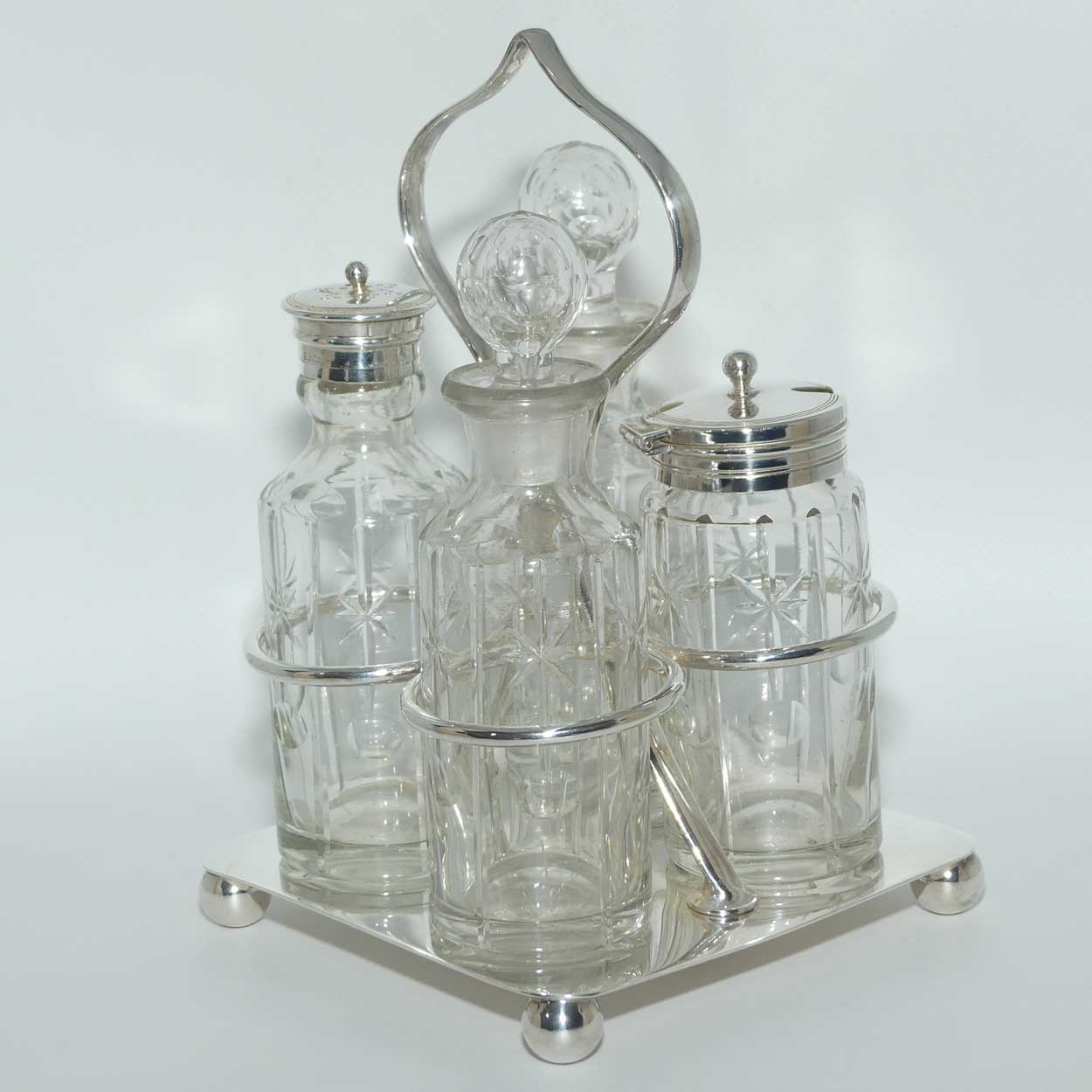 Nice quality Edwardian era 4 bottle cruet set on Silverplated stand | Finely cut bottles