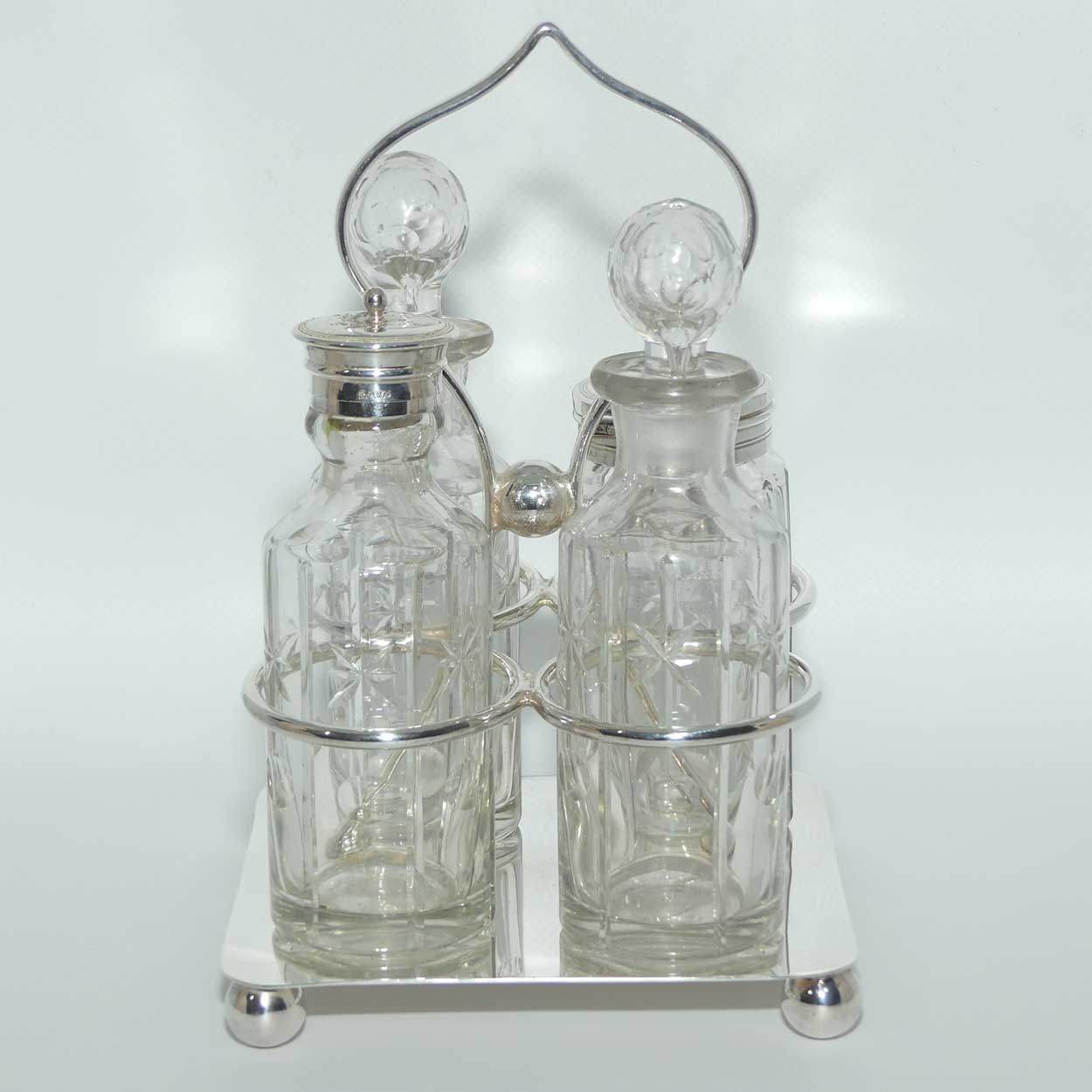Nice quality Edwardian era 4 bottle cruet set on Silverplated stand | Finely cut bottles