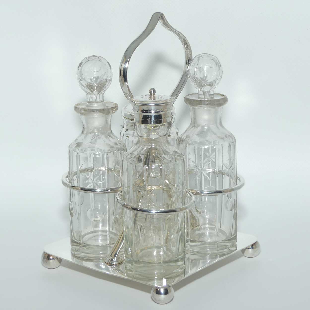 Nice quality Edwardian era 4 bottle cruet set on Silverplated stand | Finely cut bottles