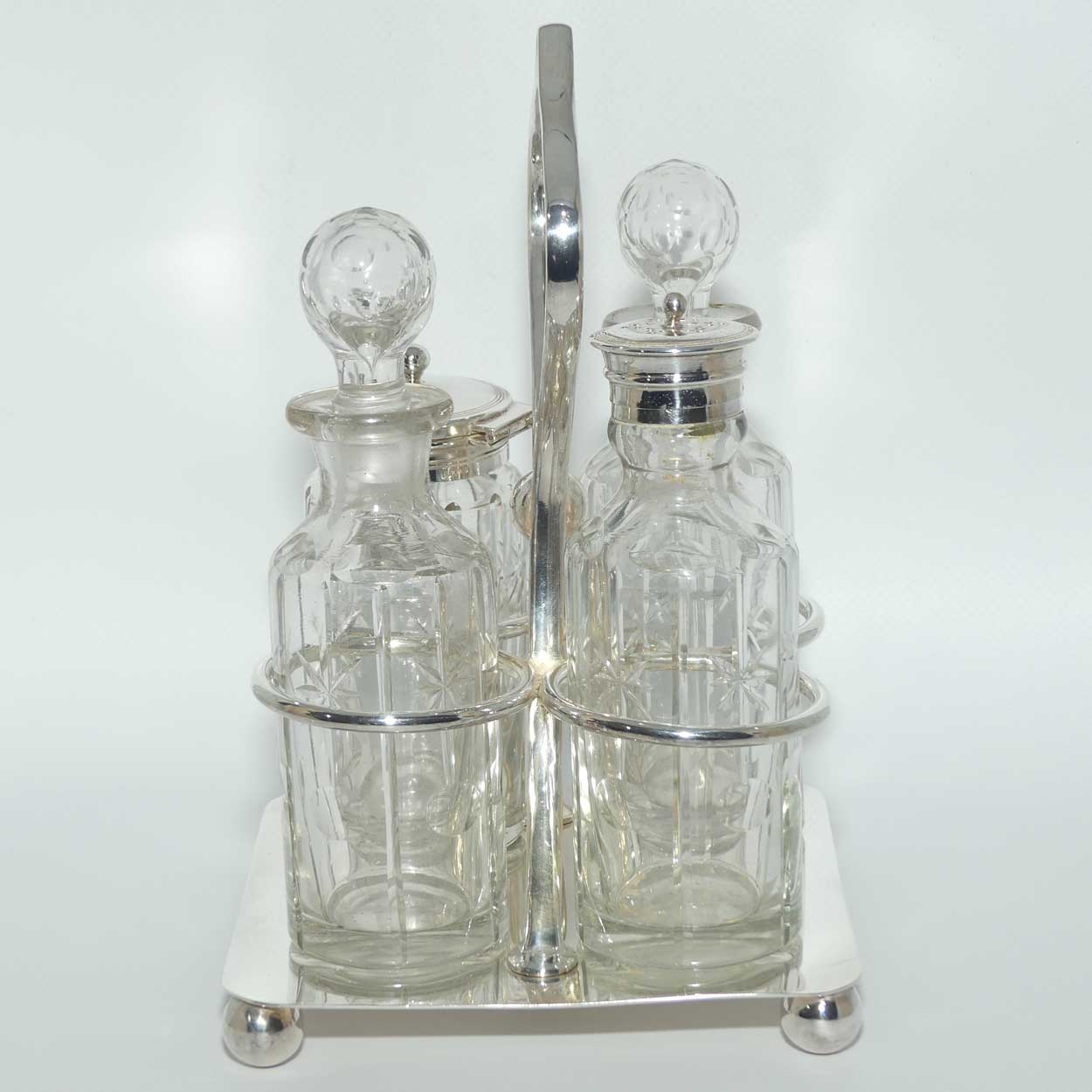 Nice quality Edwardian era 4 bottle cruet set on Silverplated stand | Finely cut bottles