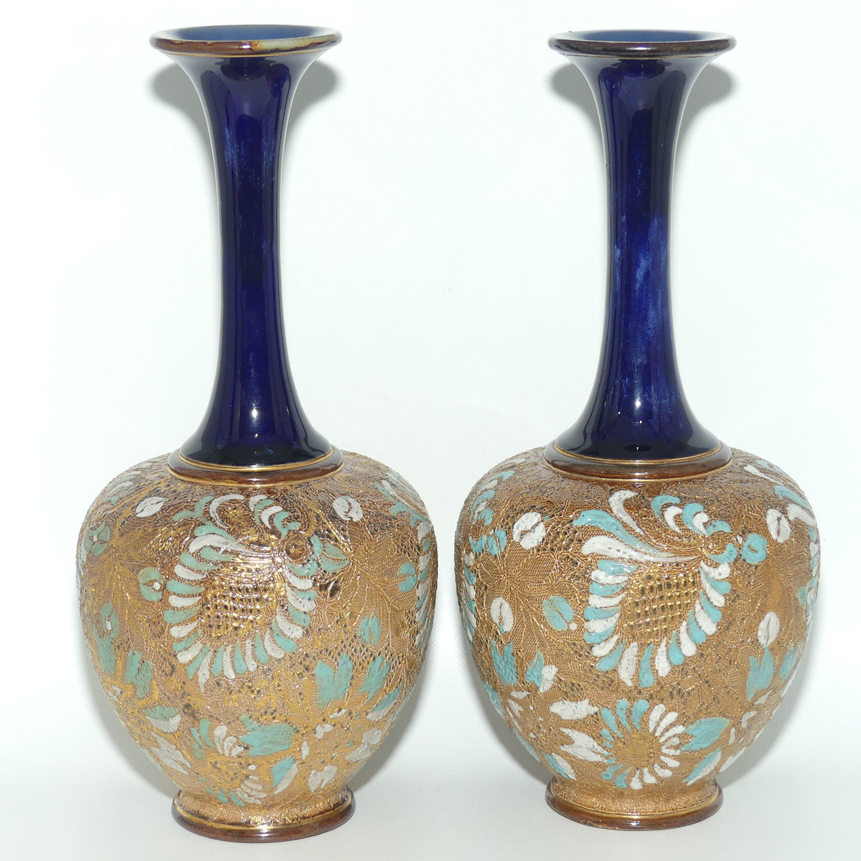 Doulton Slaters Pr of stoneware narrow neck vases with blue & white enamelling & gilt highlights (stamped 5098, painted X5094)