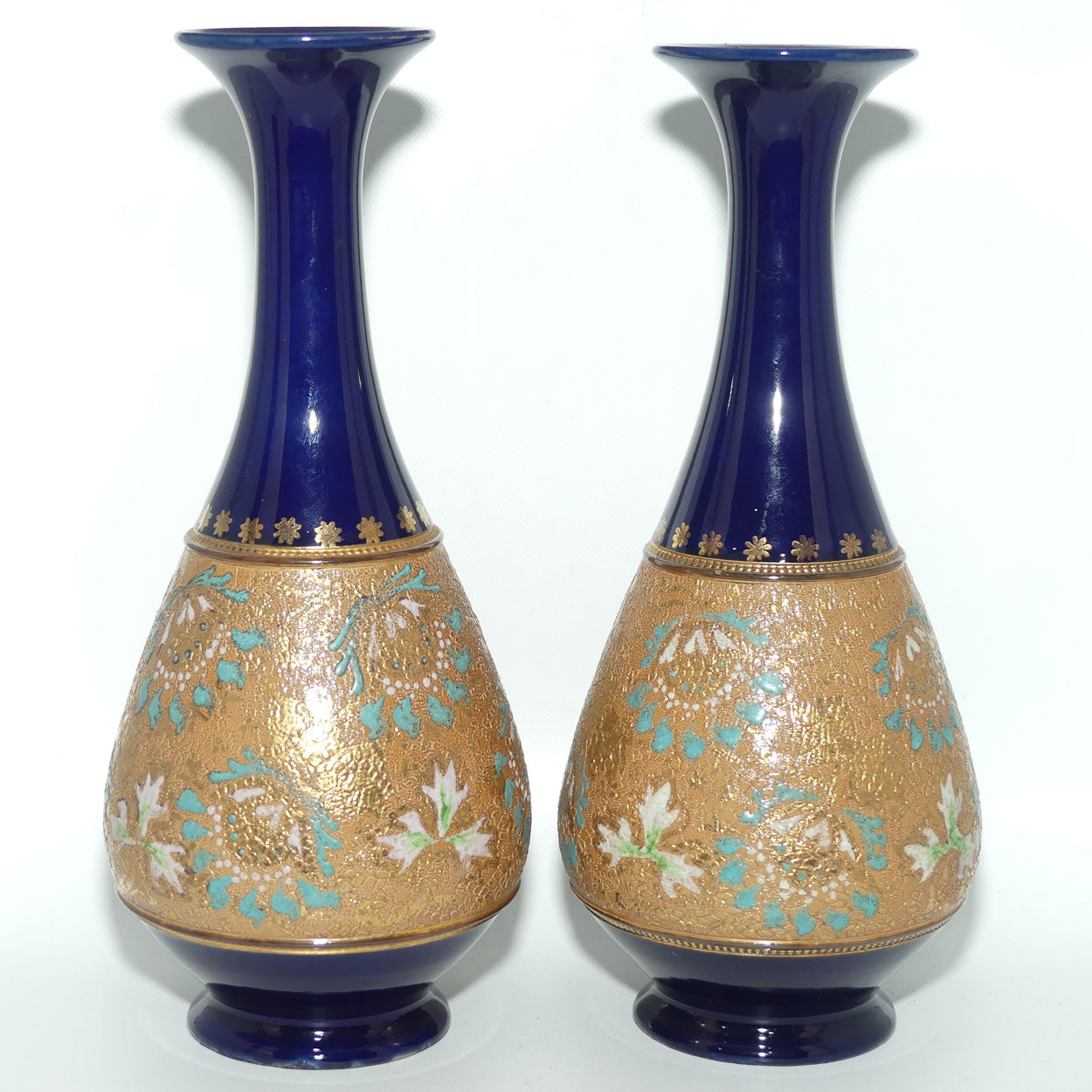 Doulton Slaters stoneware pair of narrowneck bulbous vases with blue, white & green enamelling and gilt highlights (stamped 672)