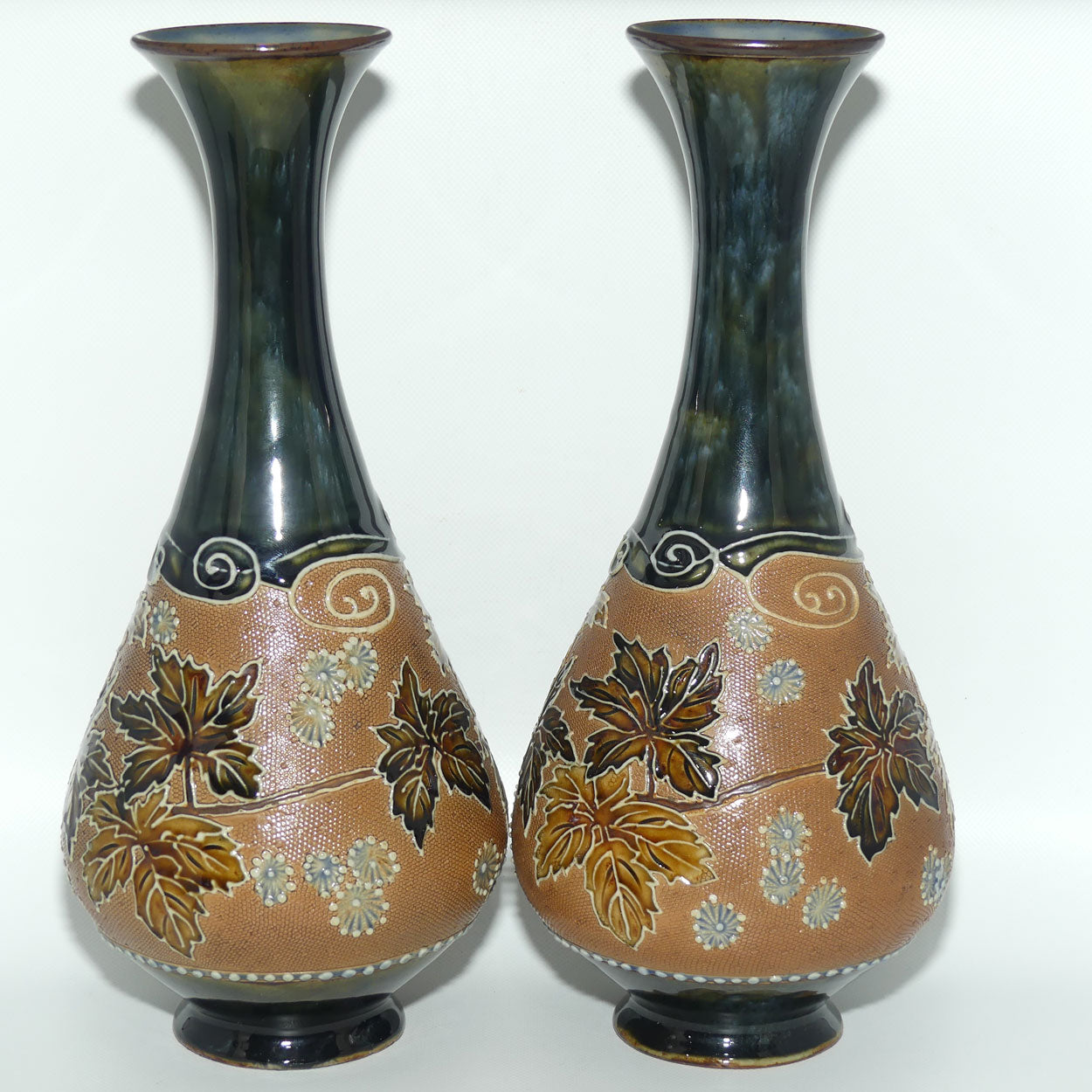 Royal Doulton pair of stoneware vases with applied foliage and scrolling (stamped 6767)