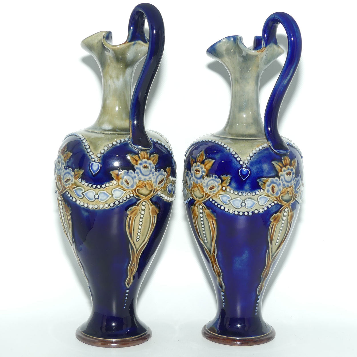 Royal Doulton pair of stoneware ewers with applied flowers, hearts and dots (stamped 7018)