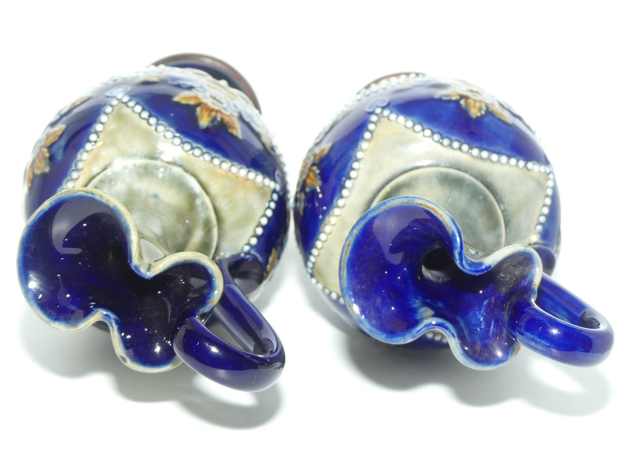 Royal Doulton pair of stoneware ewers with applied flowers, hearts and dots (stamped 7018)