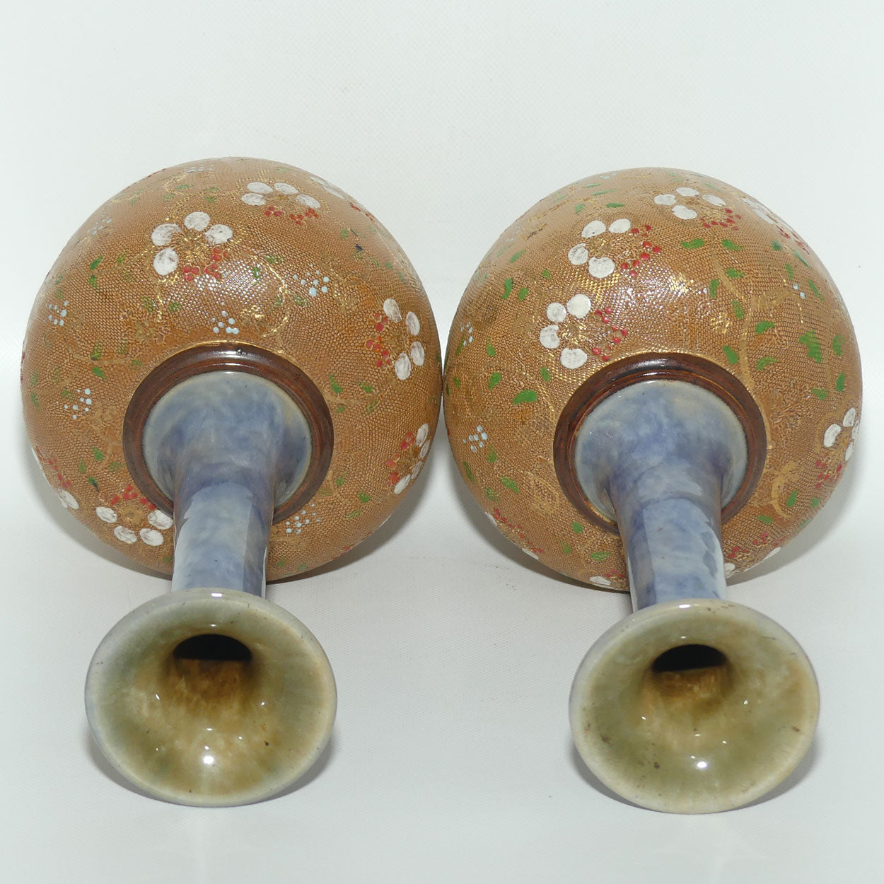 Royal Doulton pair of stoneware narrowneck bulbous vases with red, white & green enamelling and gilt highlights (stamped 8420)