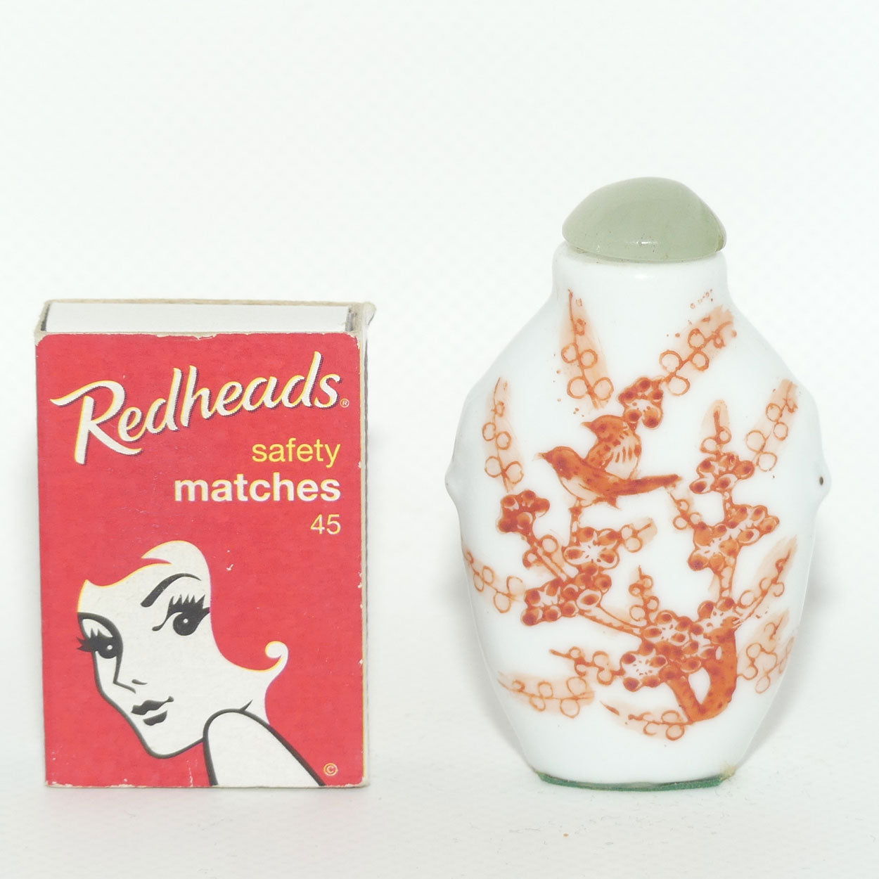 Chinese snuff bottle with greenstone stopper | Iron Red Birds in Cherry Blossom Tree