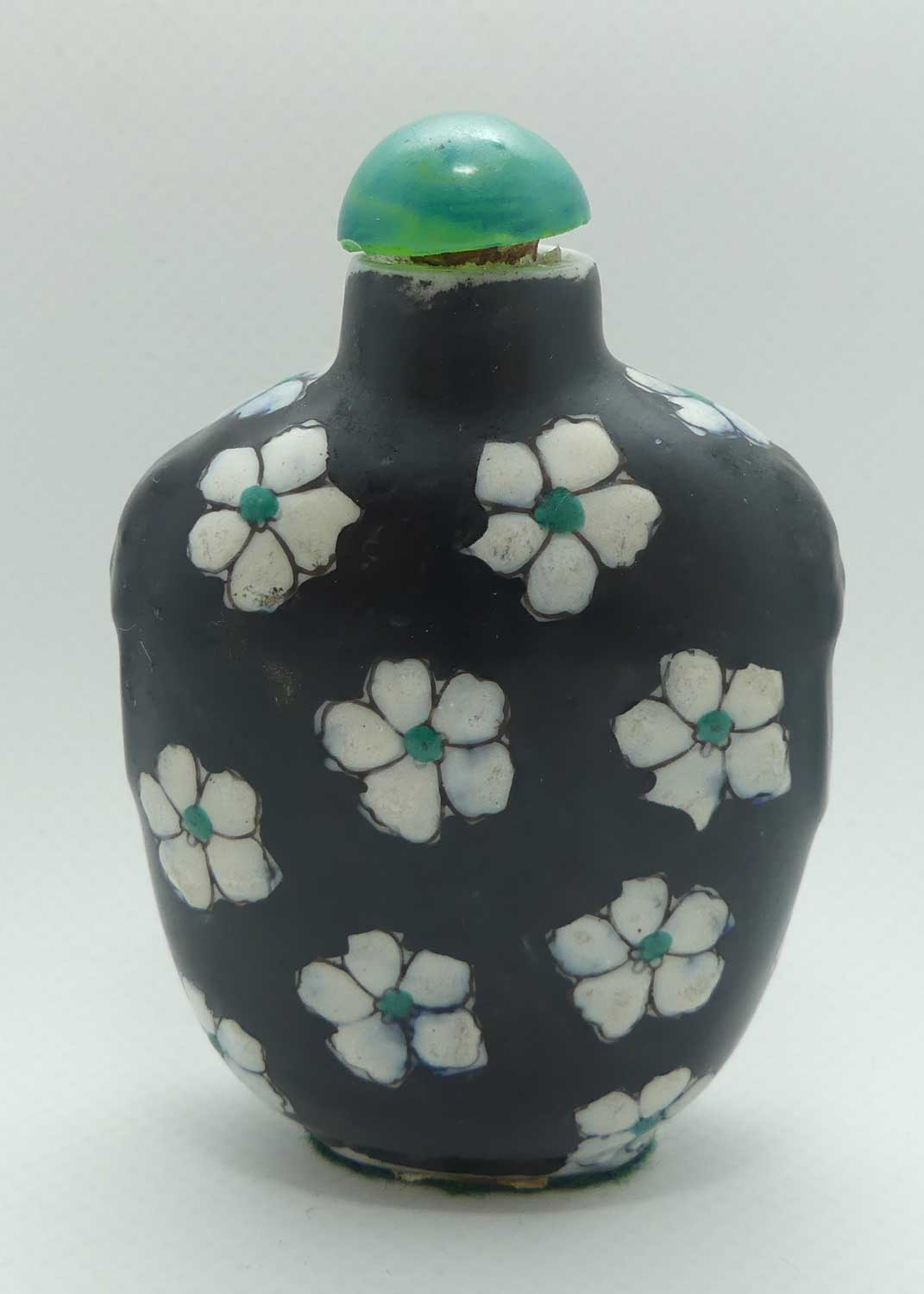 Chinese Black Ground and White Floral pattern Snuff Bottle | Green stone stopper