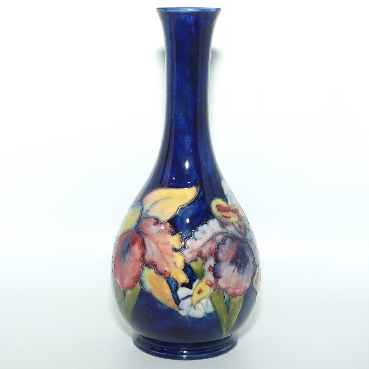 Walter Moorcroft Orchid on Dark Blue Ground tall narrow neck bottle vase