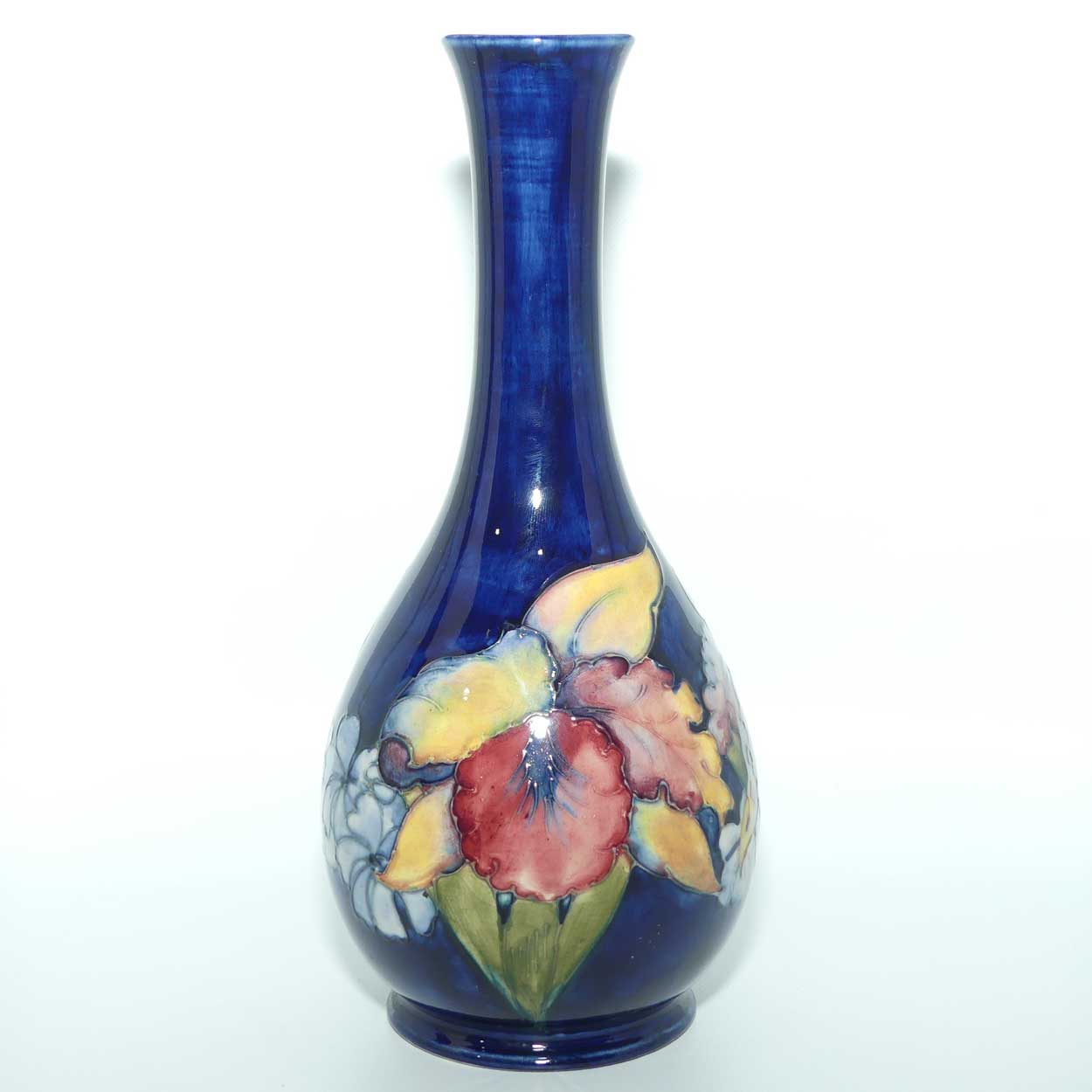 Walter Moorcroft Orchid on Dark Blue Ground tall narrow neck bottle vase