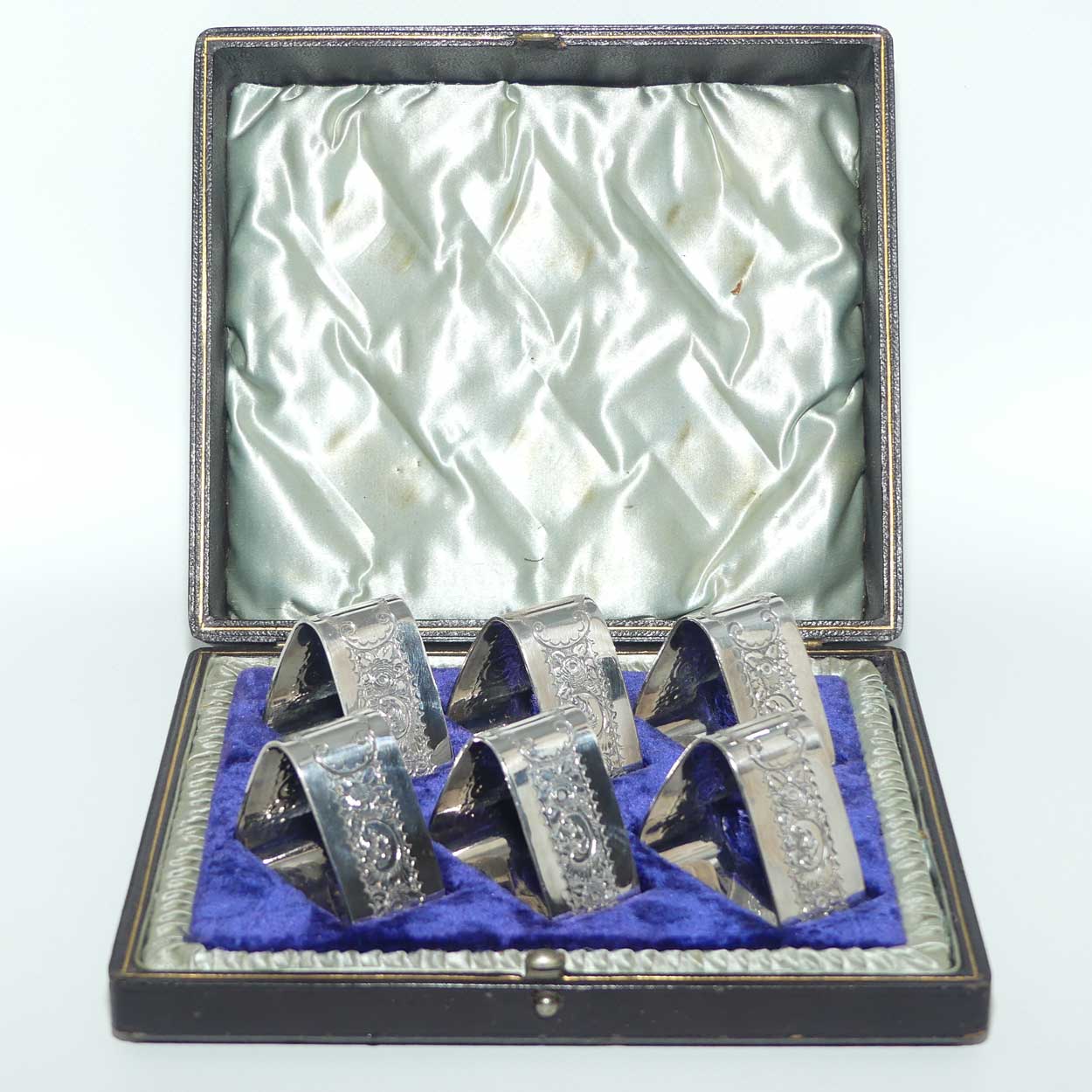 Edwardian era set of 6 Embossed triangular Silver plated napkin rings