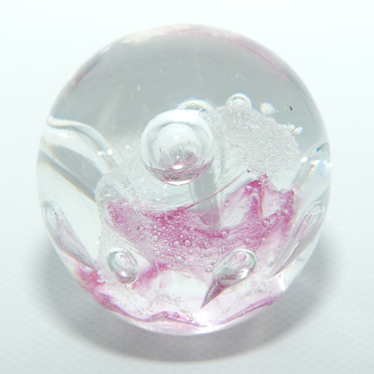 Controlled bubble within Pink Swirl paperweight