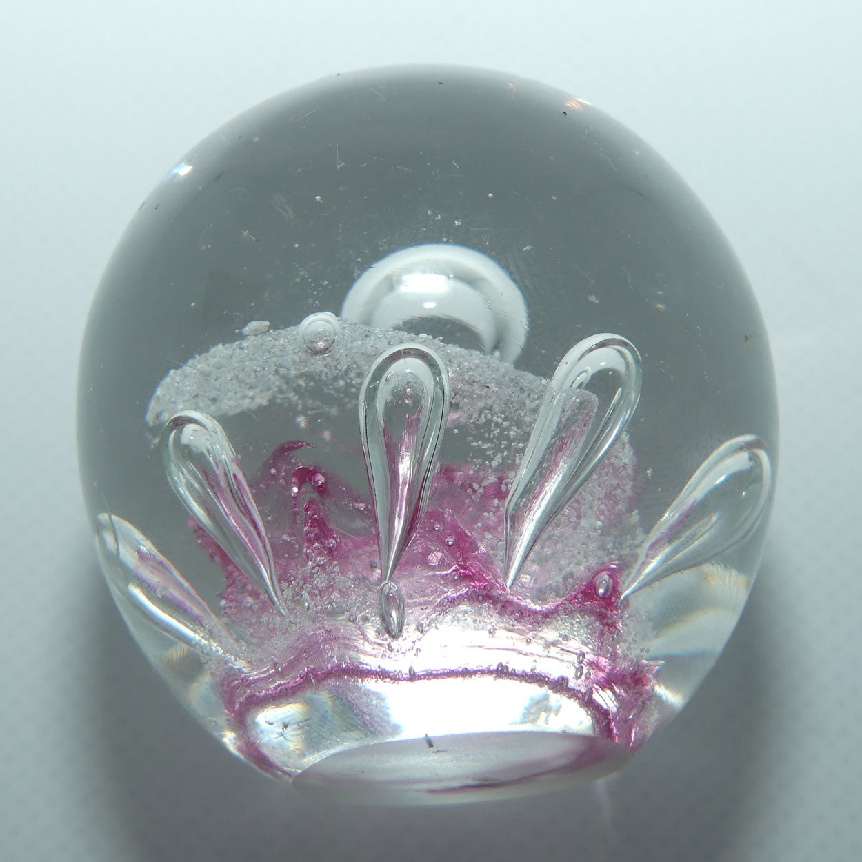 Controlled bubble within Pink Swirl paperweight