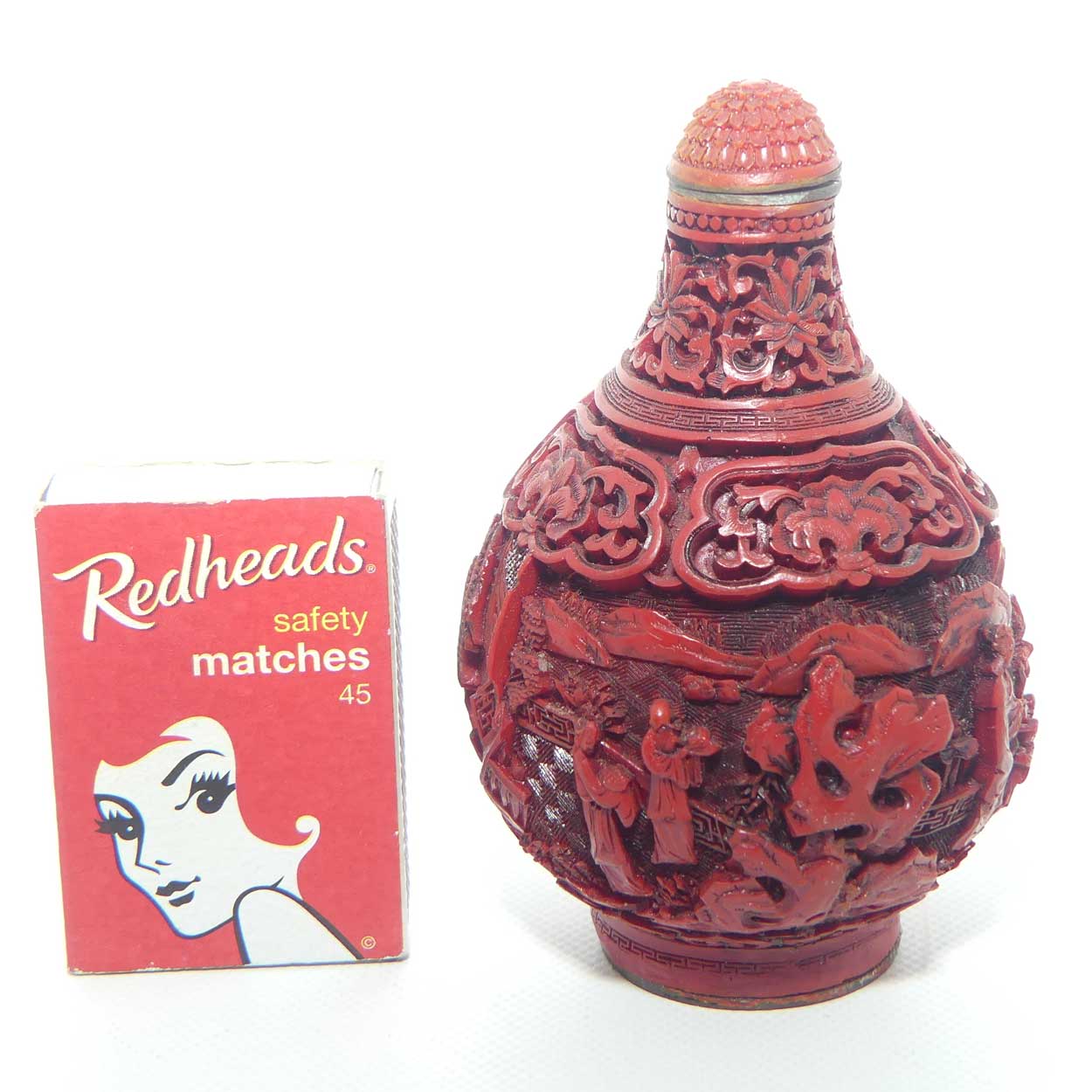 Larger size Cinnabar circular shape snuff bottle | Village and Lake scene