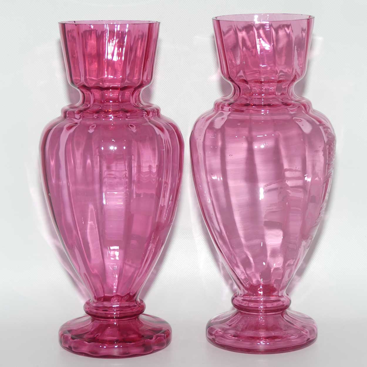 Cranberry Mary Gregory pair of vases depicting a boy with a walking cane and a girl on tip toes