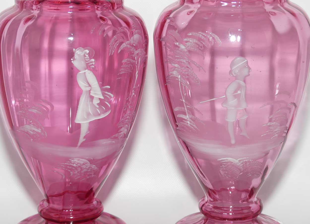Cranberry Mary Gregory pair of vases depicting a boy with a walking cane and a girl on tip toes