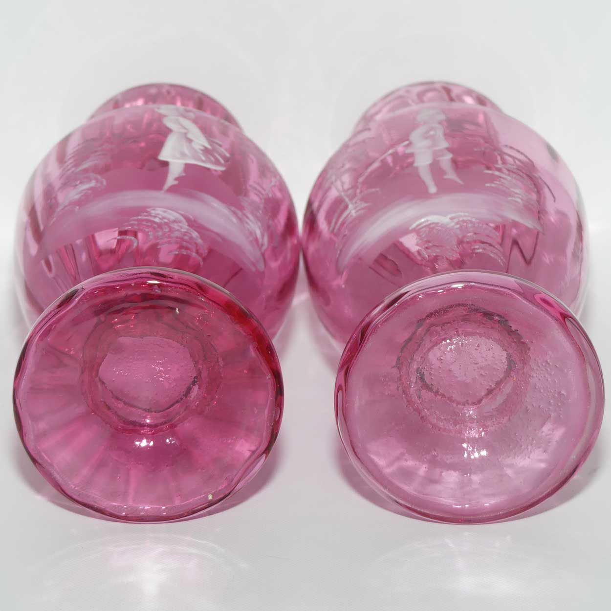 Cranberry Mary Gregory pair of vases depicting a boy with a walking cane and a girl on tip toes