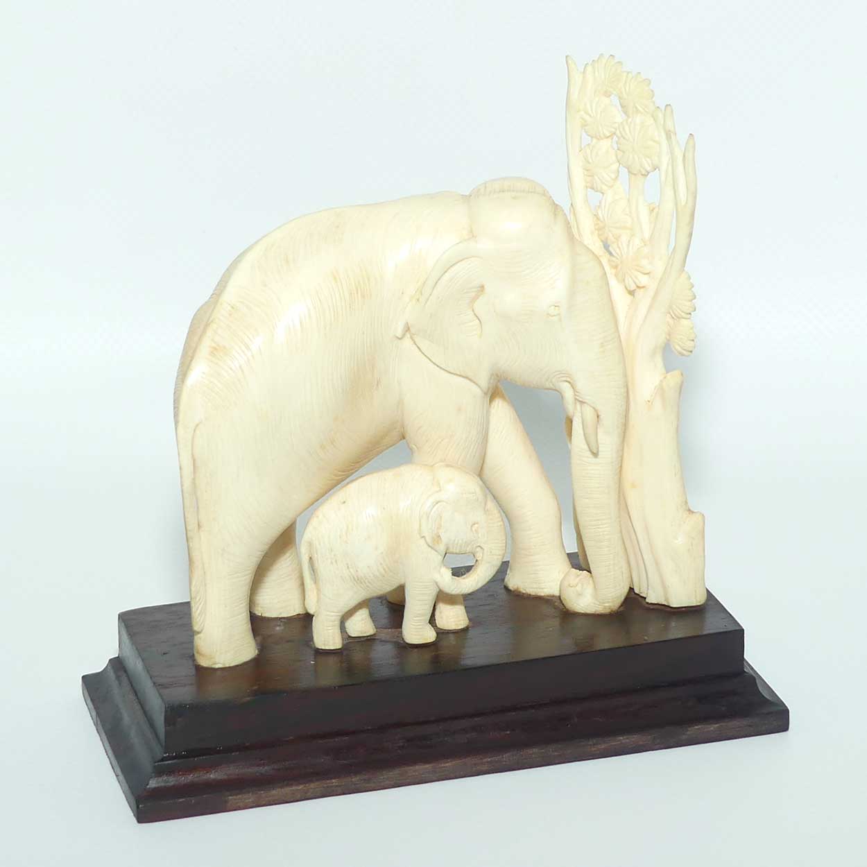 Carved Ivory figure of Mother Elephant and Calf on Rosewood Base