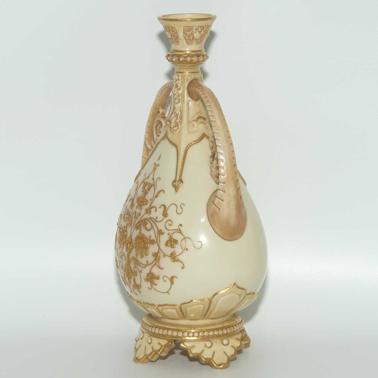 Royal Worcester Blush Ivory heavily gilt handled vase on quad feet