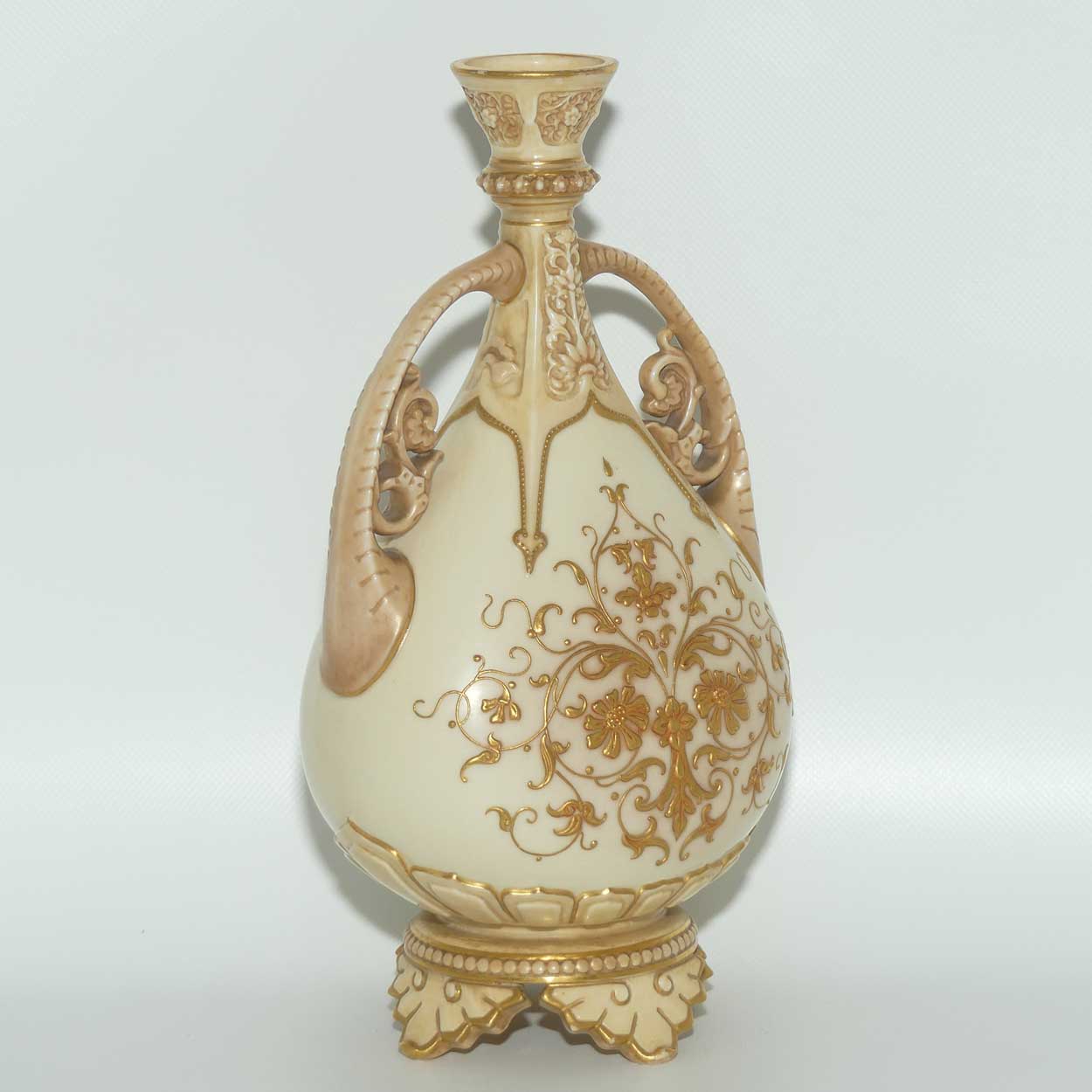 Royal Worcester Blush Ivory heavily gilt handled vase on quad feet