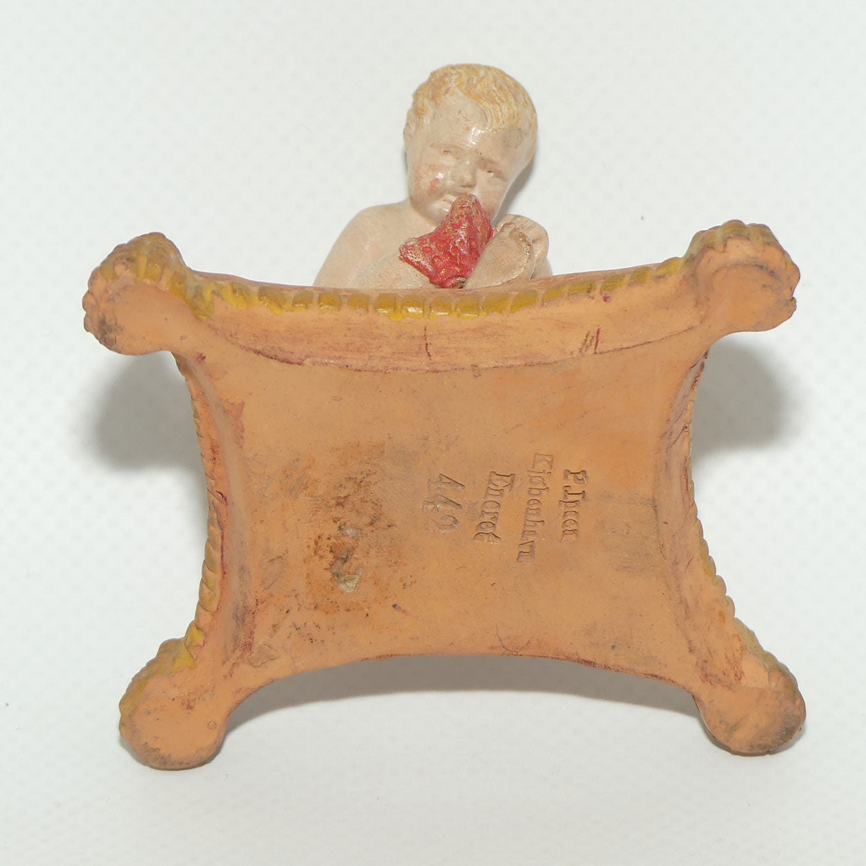 P. Ipsens Eneret terracotta figure of a baby on cushion | 442