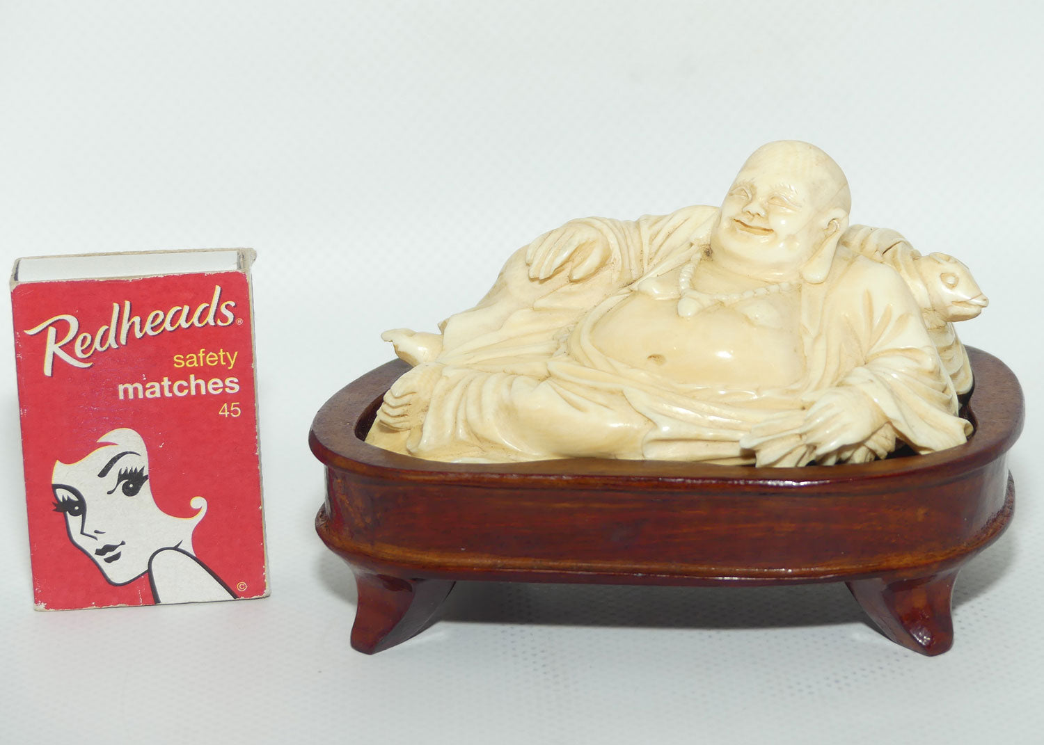 Elaborately carved Ivory Reclining Laughing Buddha on Wooden Stand | signed piece