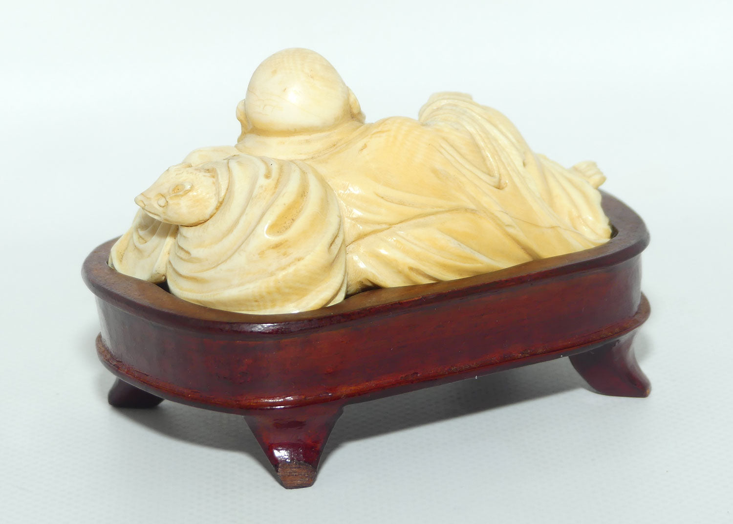 Elaborately carved Ivory Reclining Laughing Buddha on Wooden Stand | signed piece