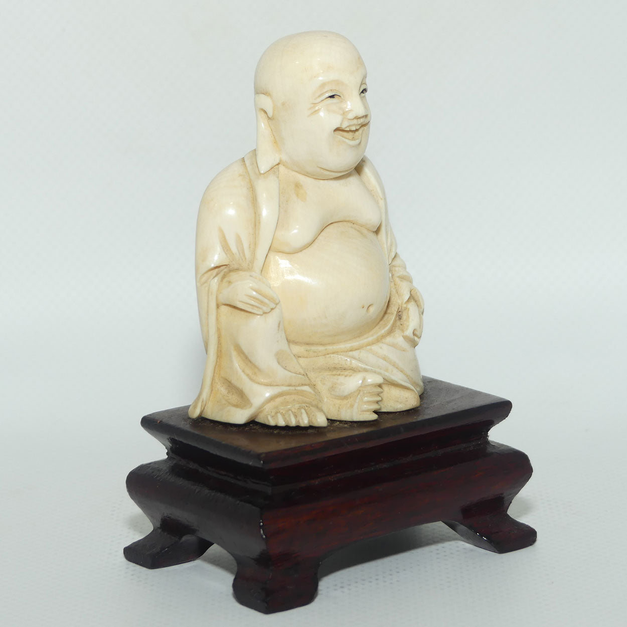 Beautifully carved Ivory Laughing Buddha Seated on Wooden Stand