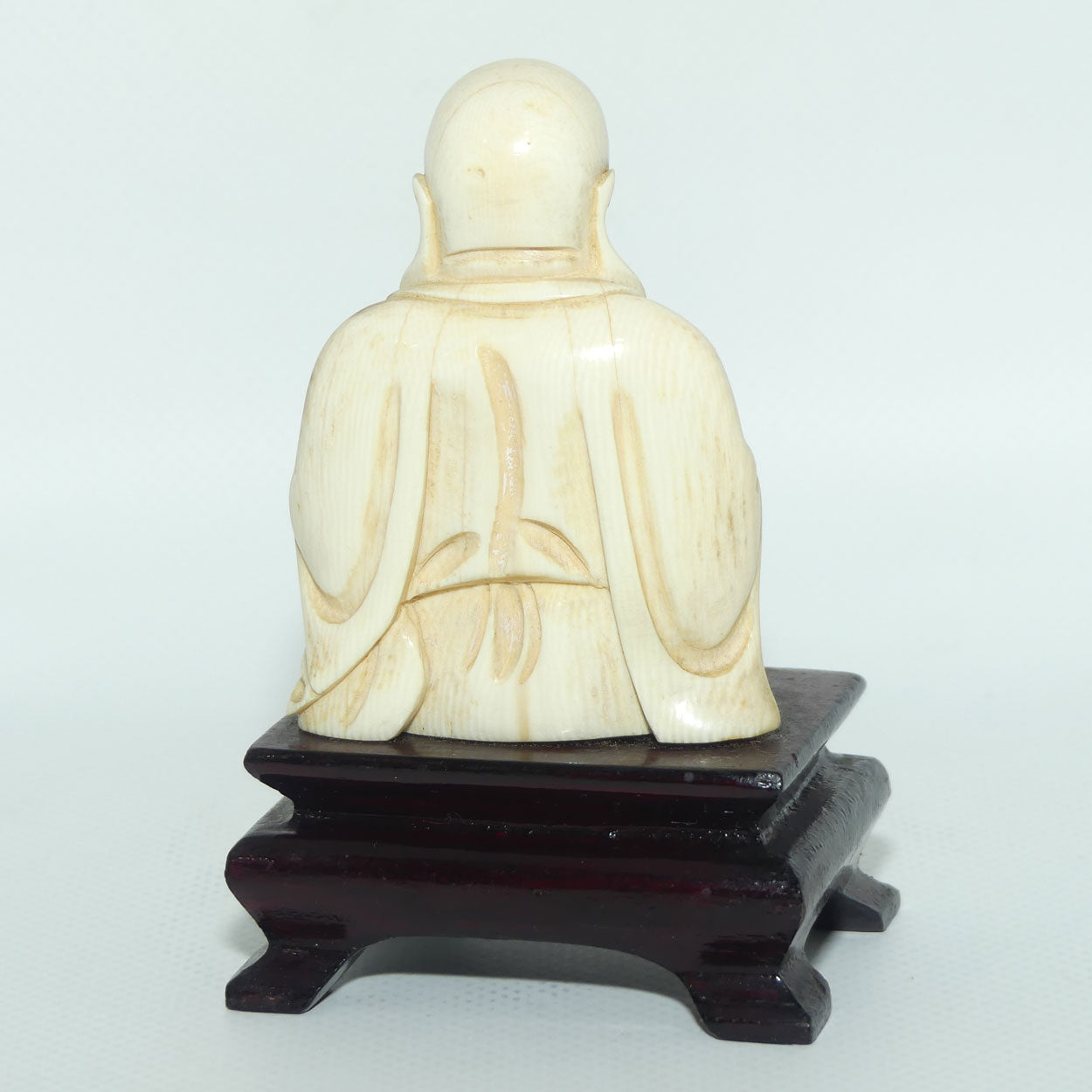 Beautifully carved Ivory Laughing Buddha Seated on Wooden Stand