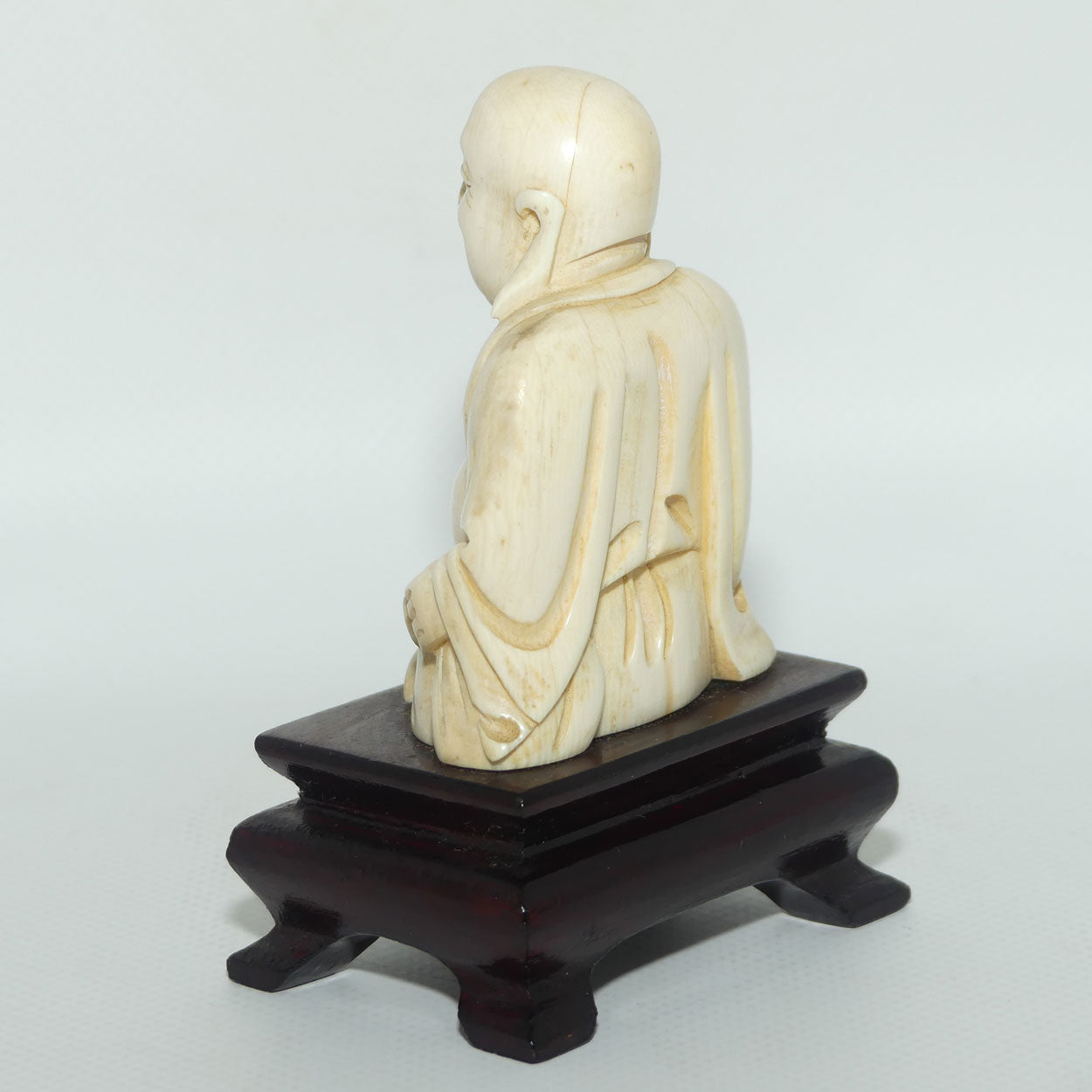 Beautifully carved Ivory Laughing Buddha Seated on Wooden Stand
