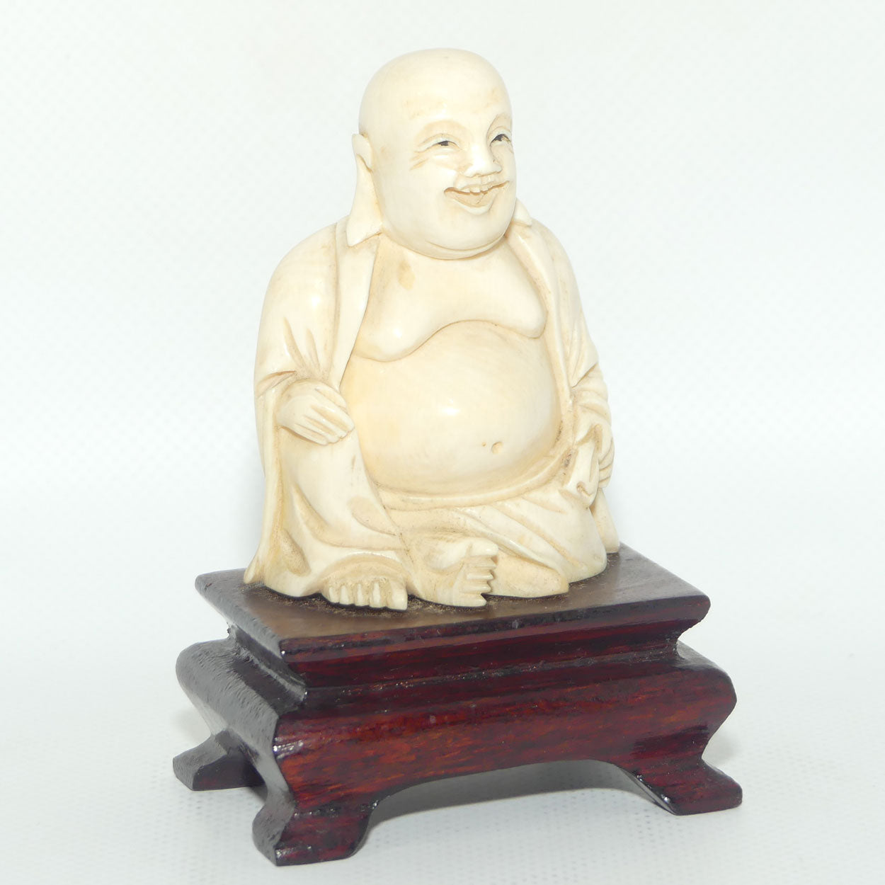Beautifully carved Ivory Laughing Buddha Seated on Wooden Stand