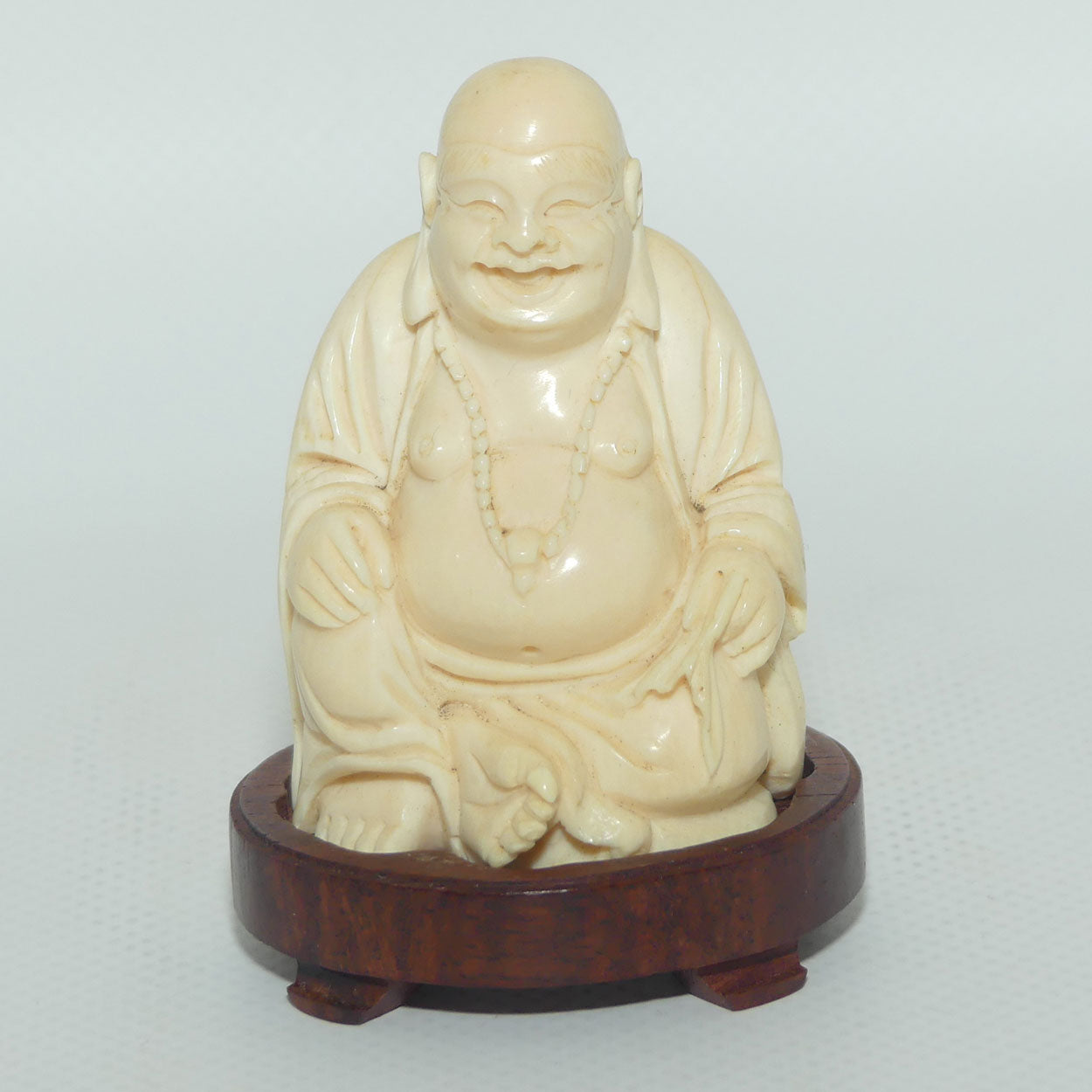 Beautifully carved Ivory Laughing Buddha Seated on Wooden Stand | signed | 7.5cm tall