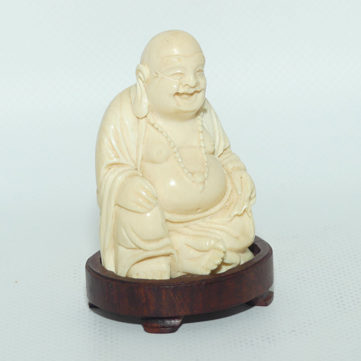 Beautifully carved Ivory Laughing Buddha Seated on Wooden Stand | signed | 7.5cm tall