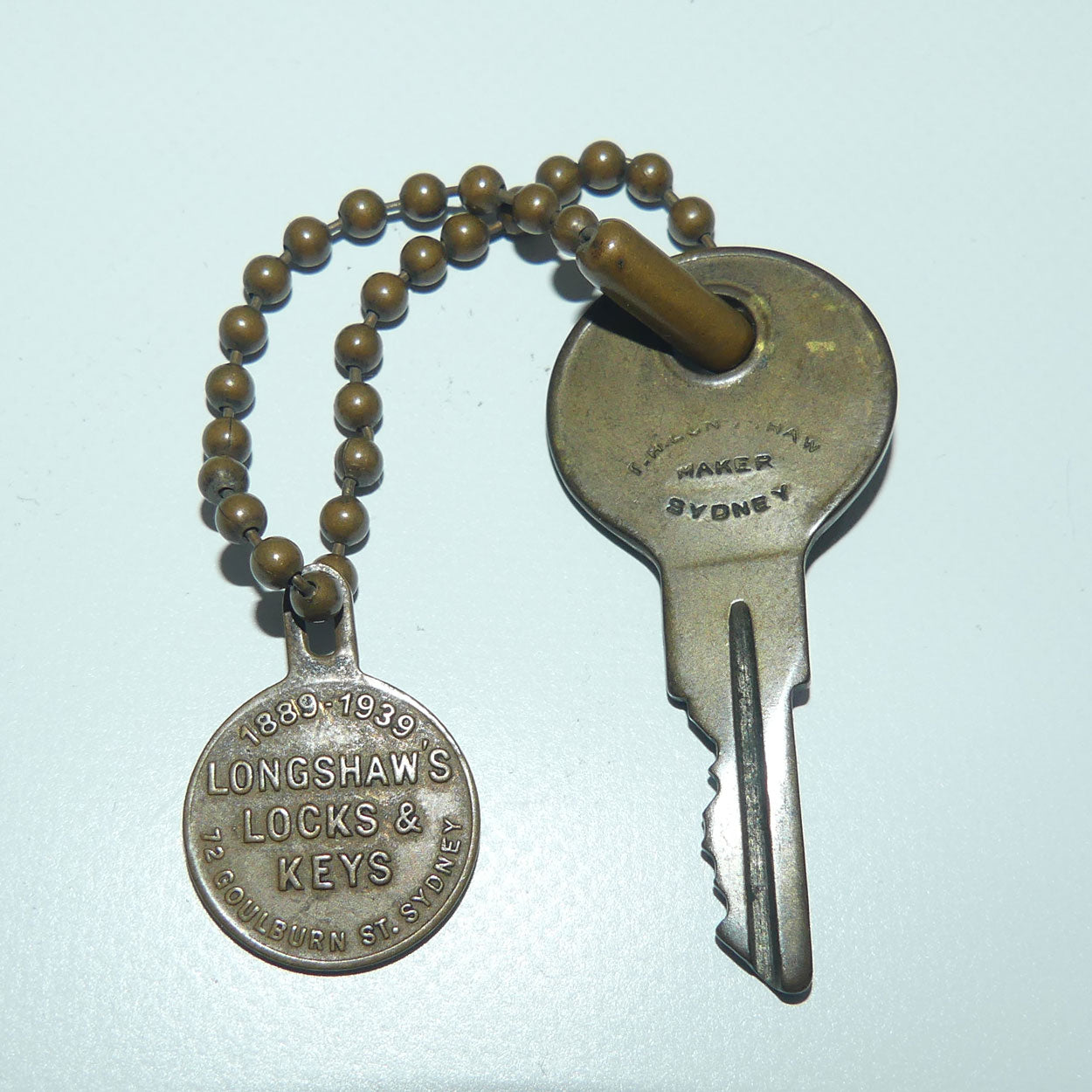TH Longshaw Locks and Keys Token + Key | 1889 - 1939 | 72 Goulburn St, Sydney
