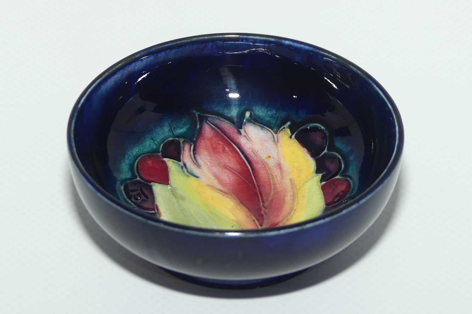 Walter Moorcroft Leaf and Fruit with Blue ground miniature footed bowl | 7.9cm diam