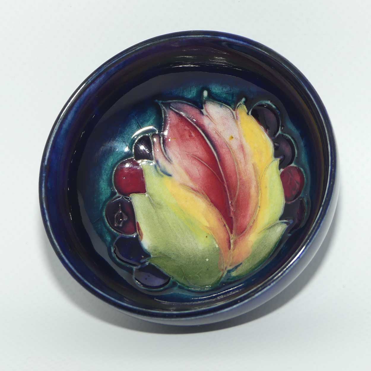 Walter Moorcroft Leaf and Fruit with Blue ground miniature footed bowl | 7.9cm diam