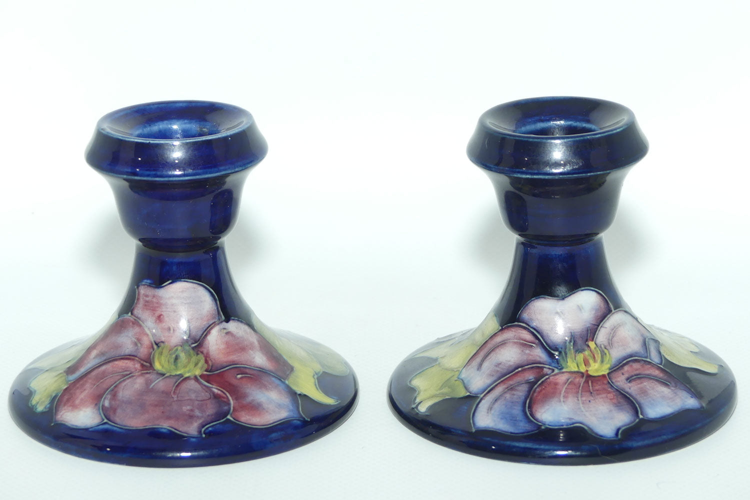 Walter Moorcroft Purple Clematis with Blue ground pair of candle holders
