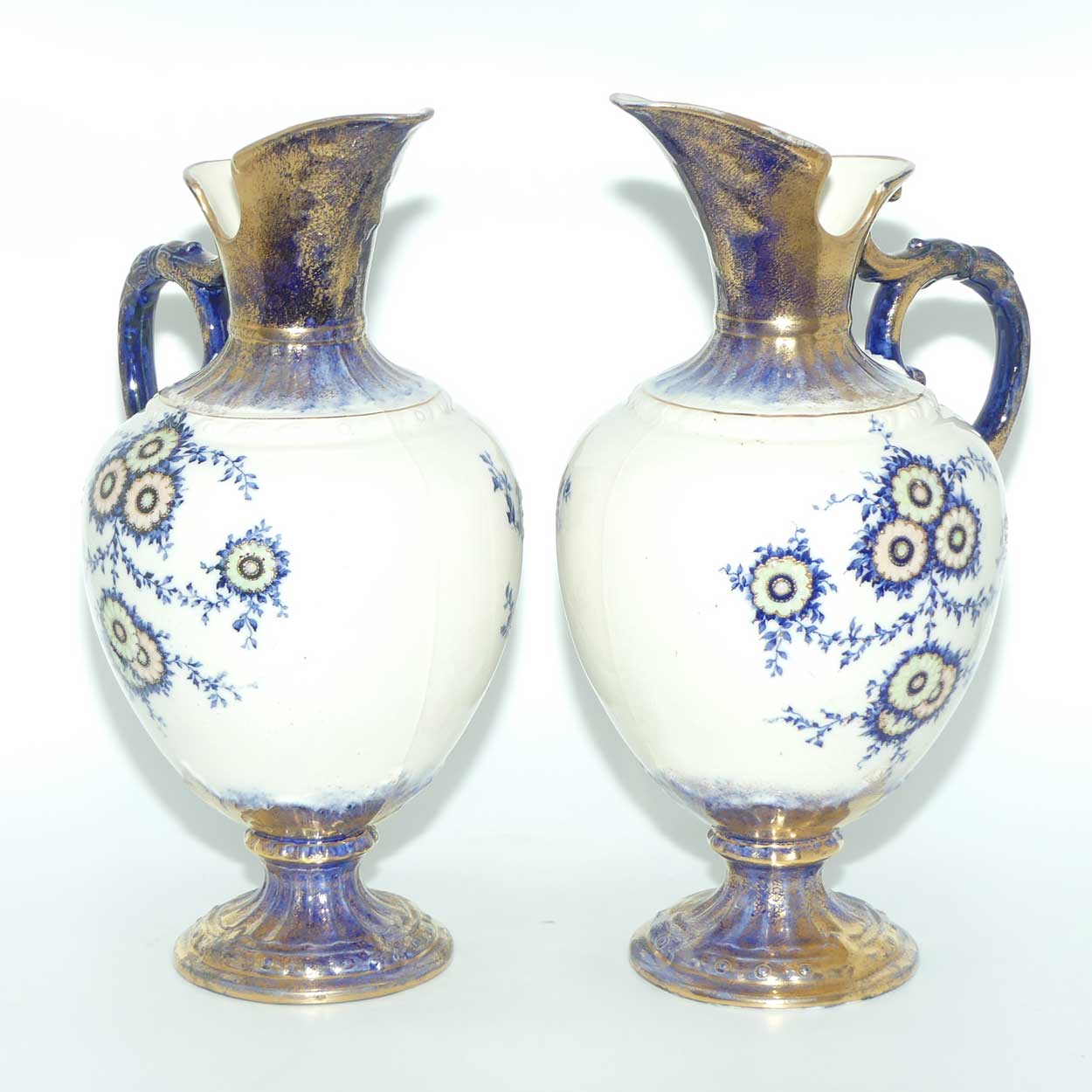Pair of Flow Blue and Gilt Staffordshire floral decorated ewers