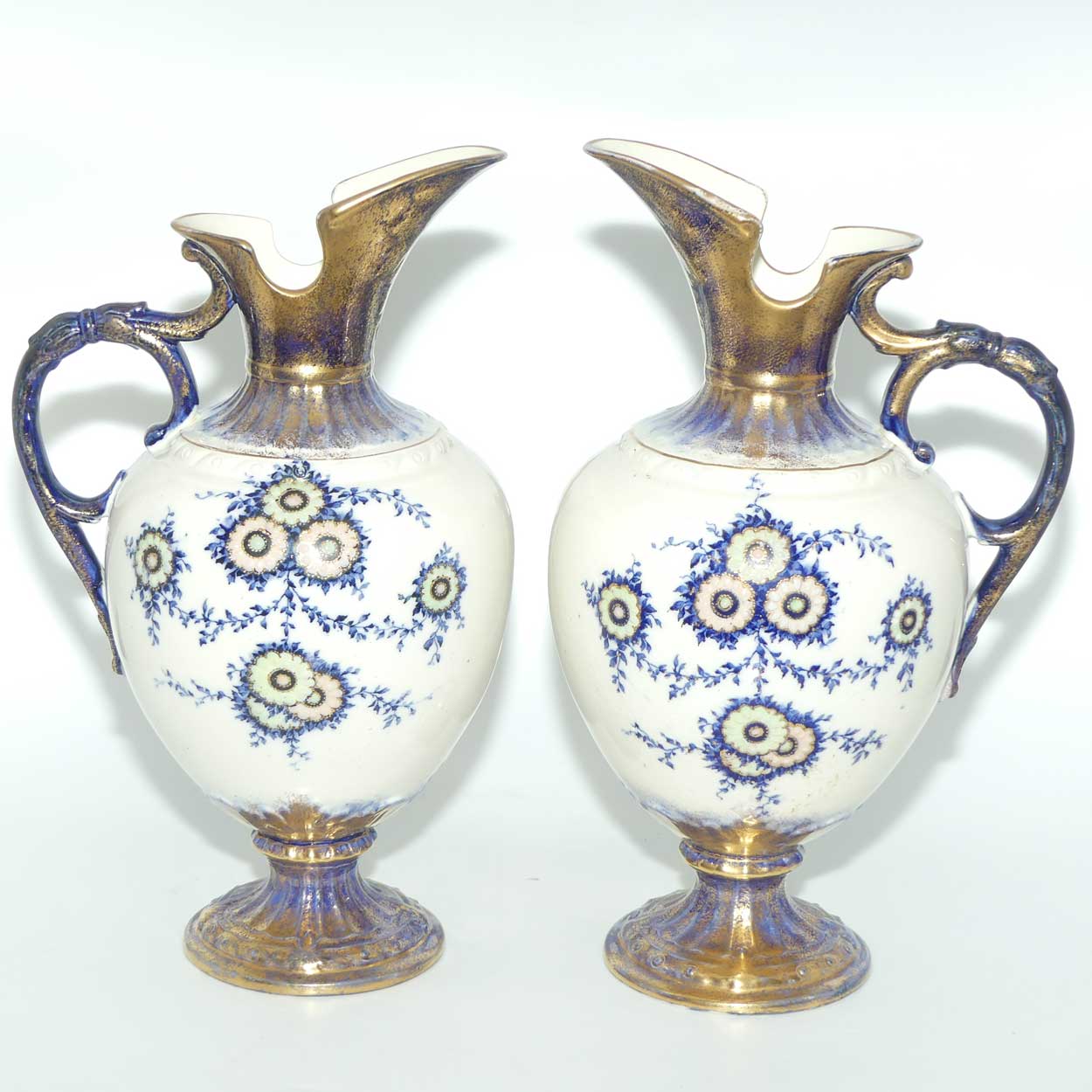 Pair of Flow Blue and Gilt Staffordshire floral decorated ewers