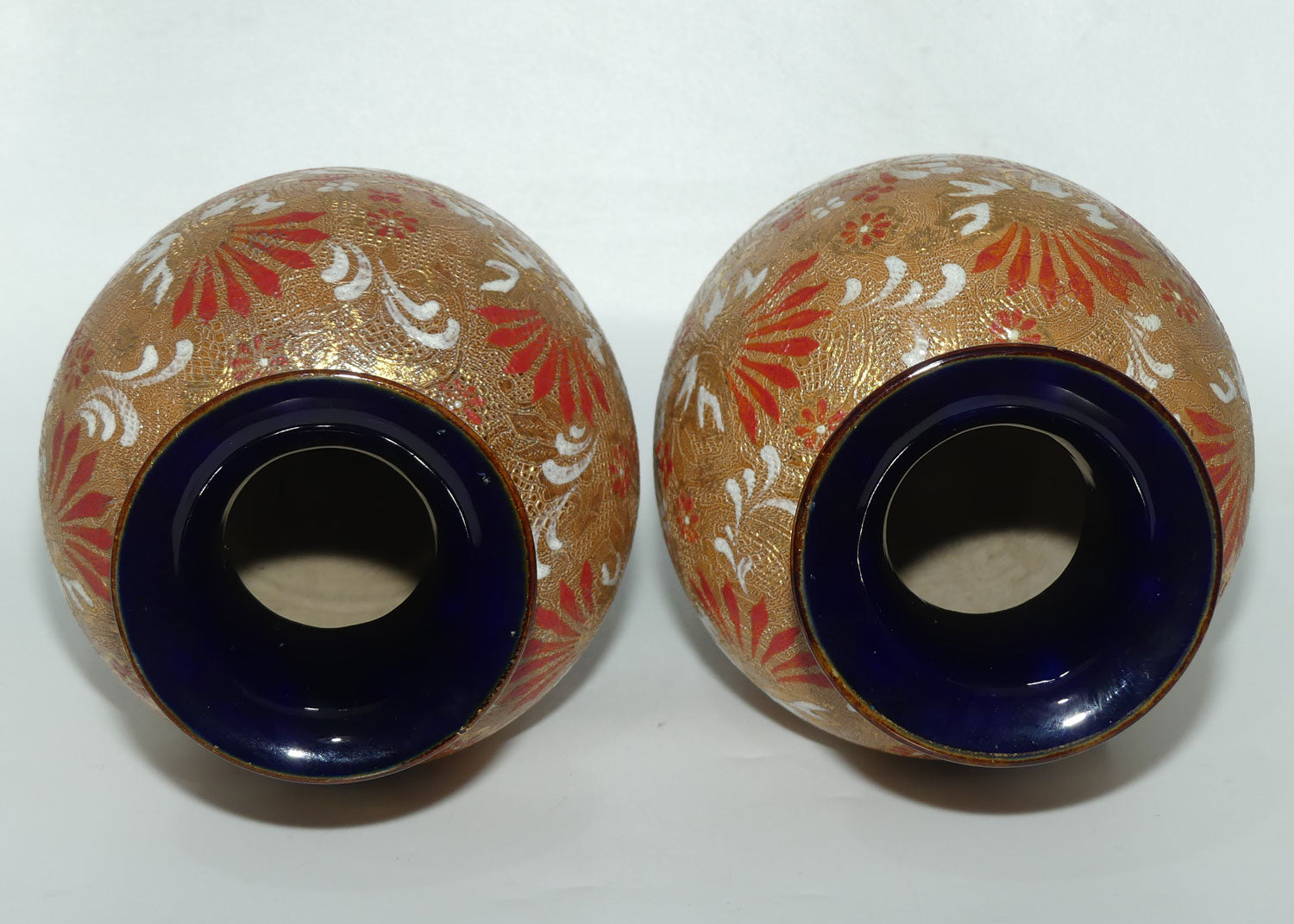 Royal Doulton stoneware pair of bulbous vases with red & white enamelled flowers, gilt highlights, applied leaves & dots (stamped 4461)