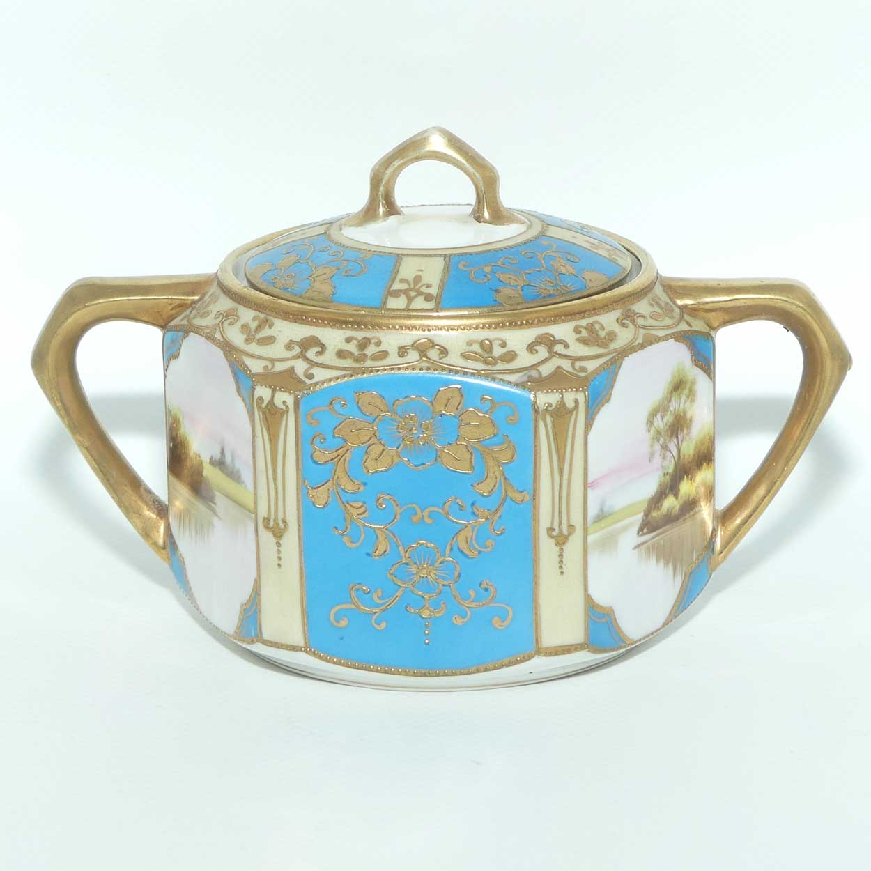 early Noritake Hand Painted and Gilt decorated Blue ground milk and sugar | Hexagonal shape | Lake Scene