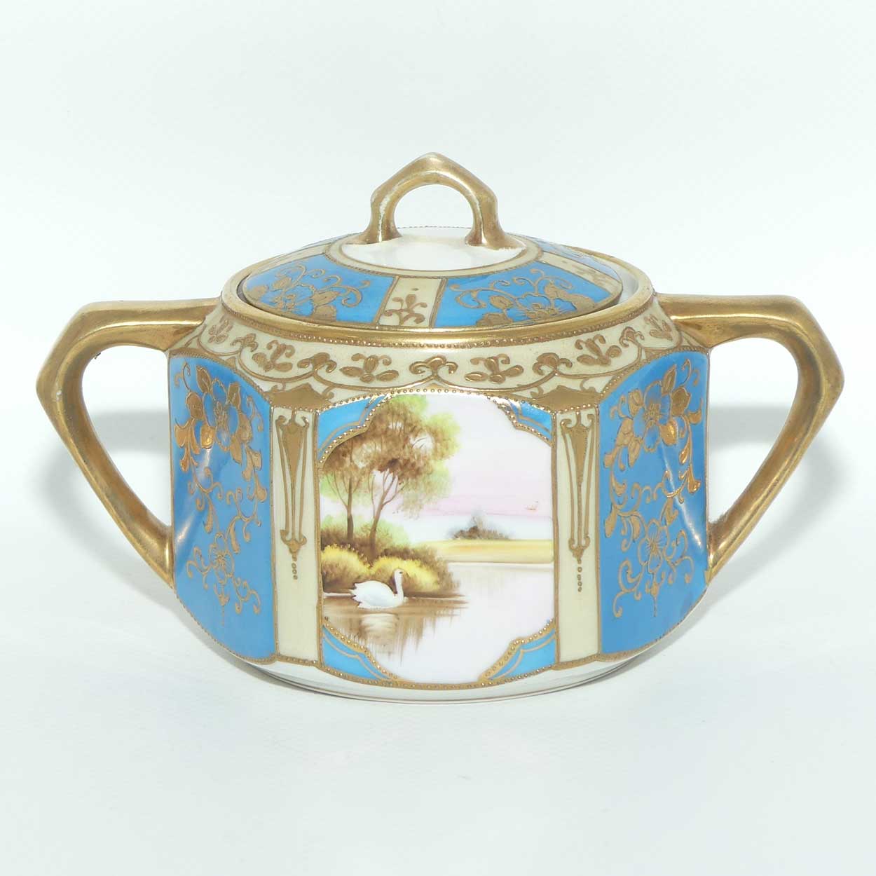 early Noritake Hand Painted and Gilt decorated Blue ground milk and sugar | Hexagonal shape | Lake Scene