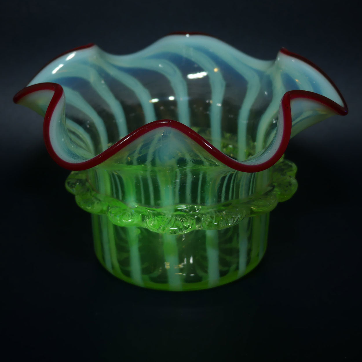 Victorian era Uranium Glass bowl with applied rigaree and Ruby edge in silver plated stand