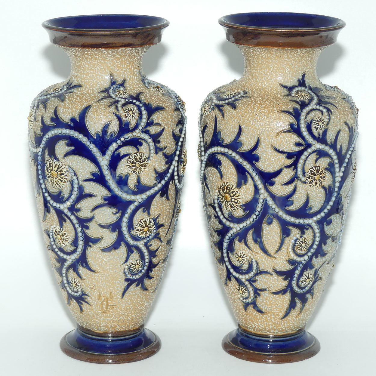 Royal Doulton stoneware George Tinworth pair of bulbous centrepiece vases with applied baguette beads and foliage
