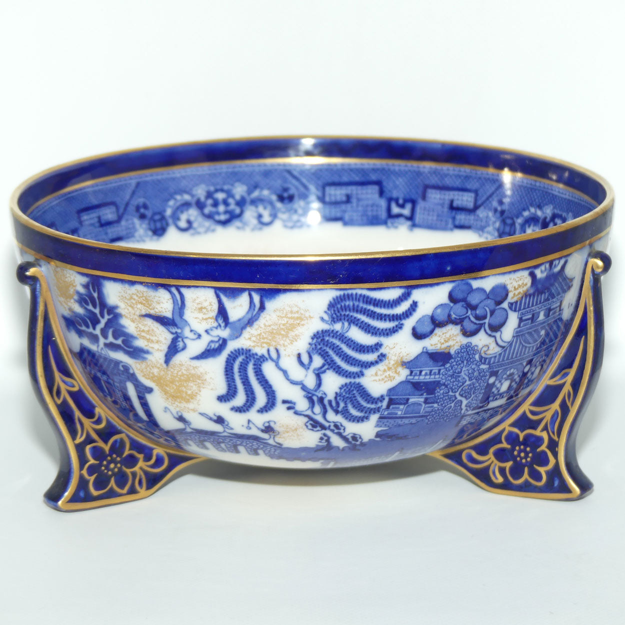 Doulton Burslem England Flow Blue Willow bowl on figured feet | unmarked