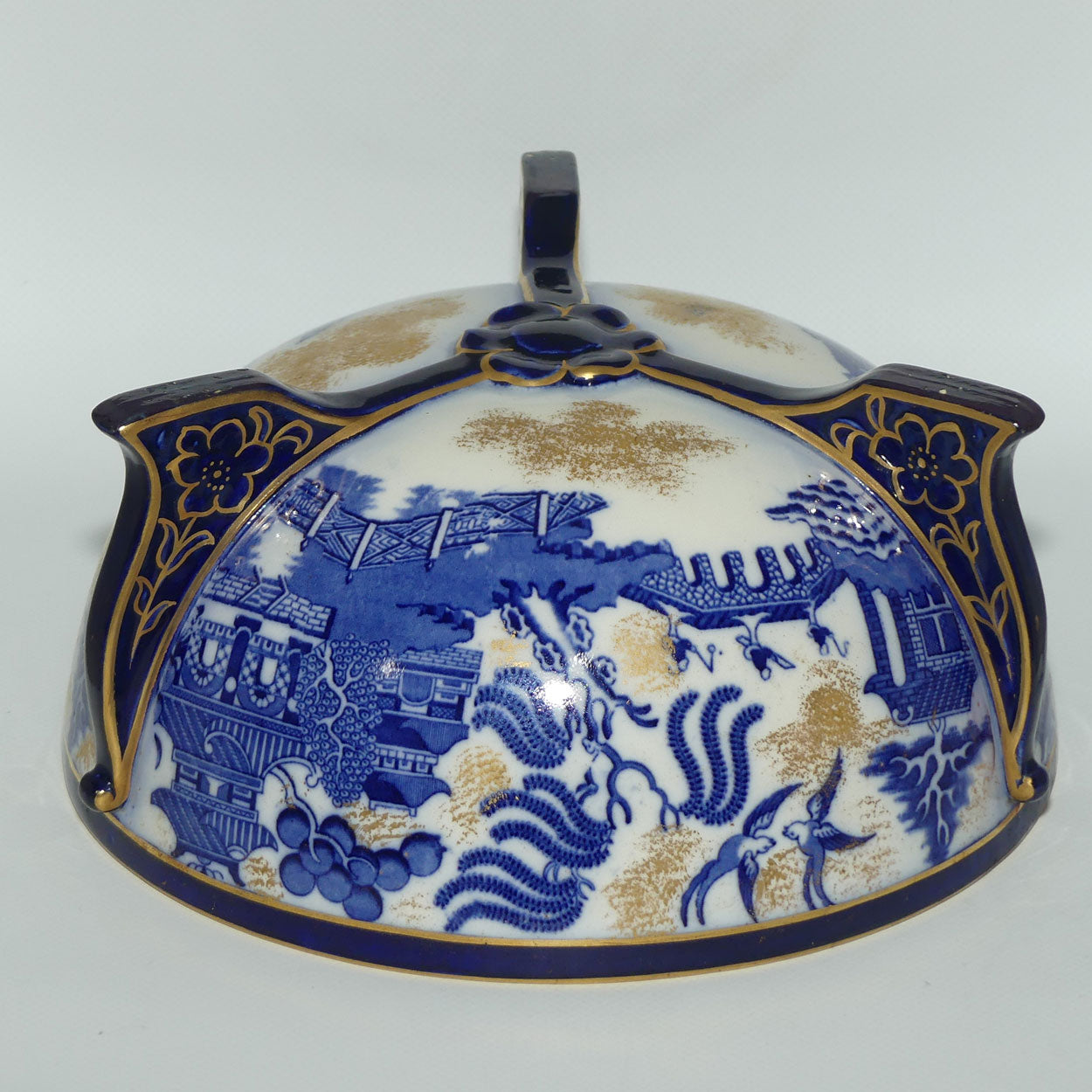 Doulton Burslem England Flow Blue Willow bowl on figured feet | unmarked