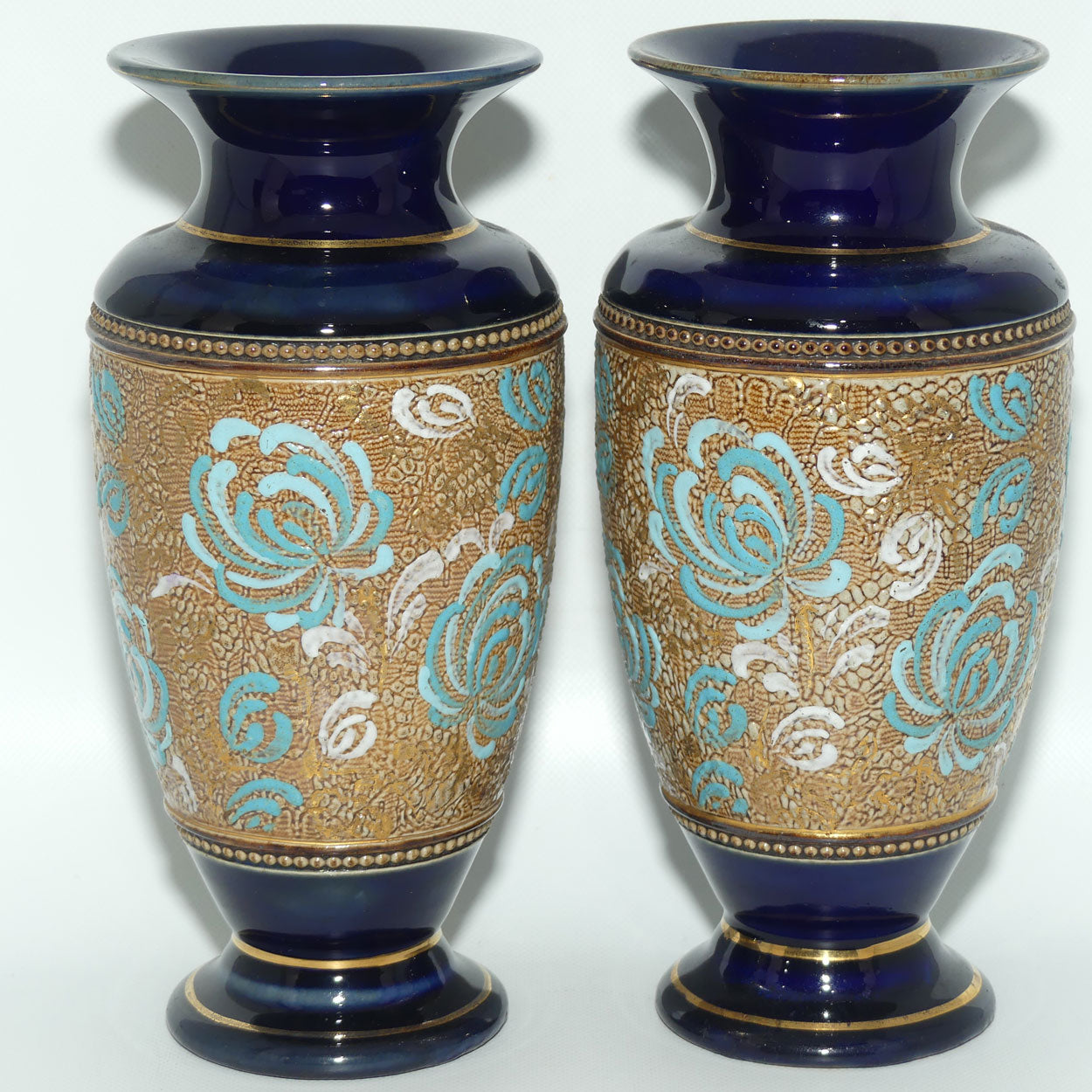 Royal Doulton pair of small stoneware vases with blue & white enamelled flowers & gilt highlights (X5564)