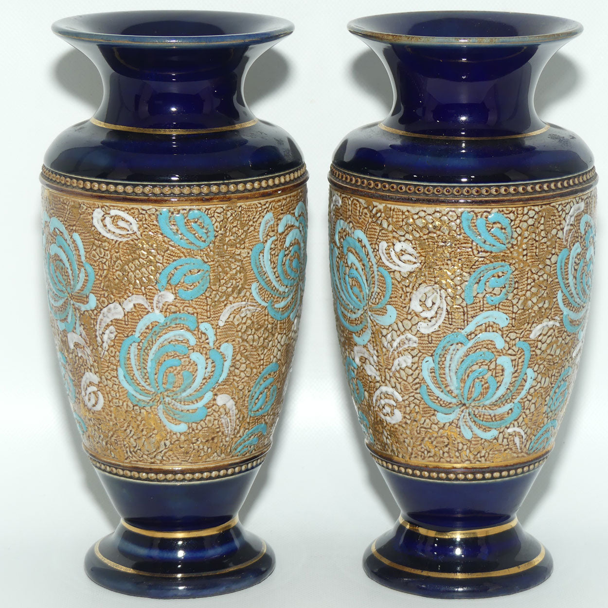 Royal Doulton pair of small stoneware vases with blue & white enamelled flowers & gilt highlights (X5564)