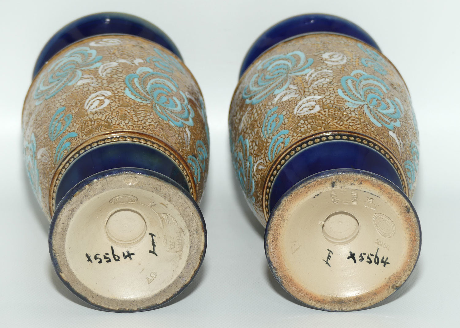 Royal Doulton pair of small stoneware vases with blue & white enamelled flowers & gilt highlights (X5564)